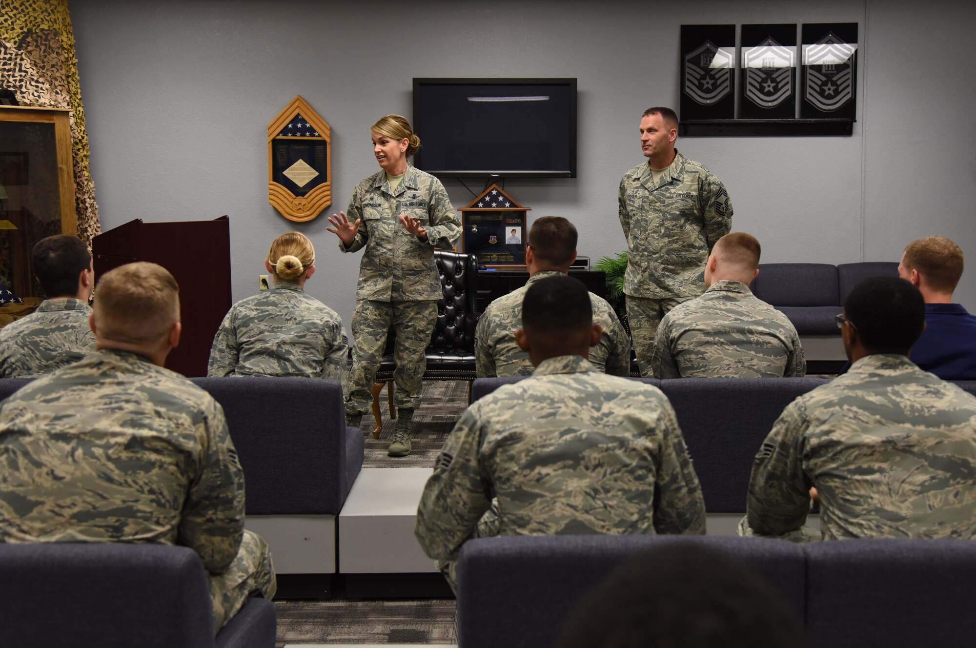 Col. Michele Edmondson, 81st Training Wing commander, briefs Airmen Leadership School students as Chief Master Sgt. Anthony Fisher, 81st Training Group superintendent, stands by inside the heritage room April 21, 2017, on Keesler Air Force Base, Miss. Edmondson visits every ALS class to brief the importance of fulfilling a leadership role. (U.S. Air Force photo by Kemberly Groue)