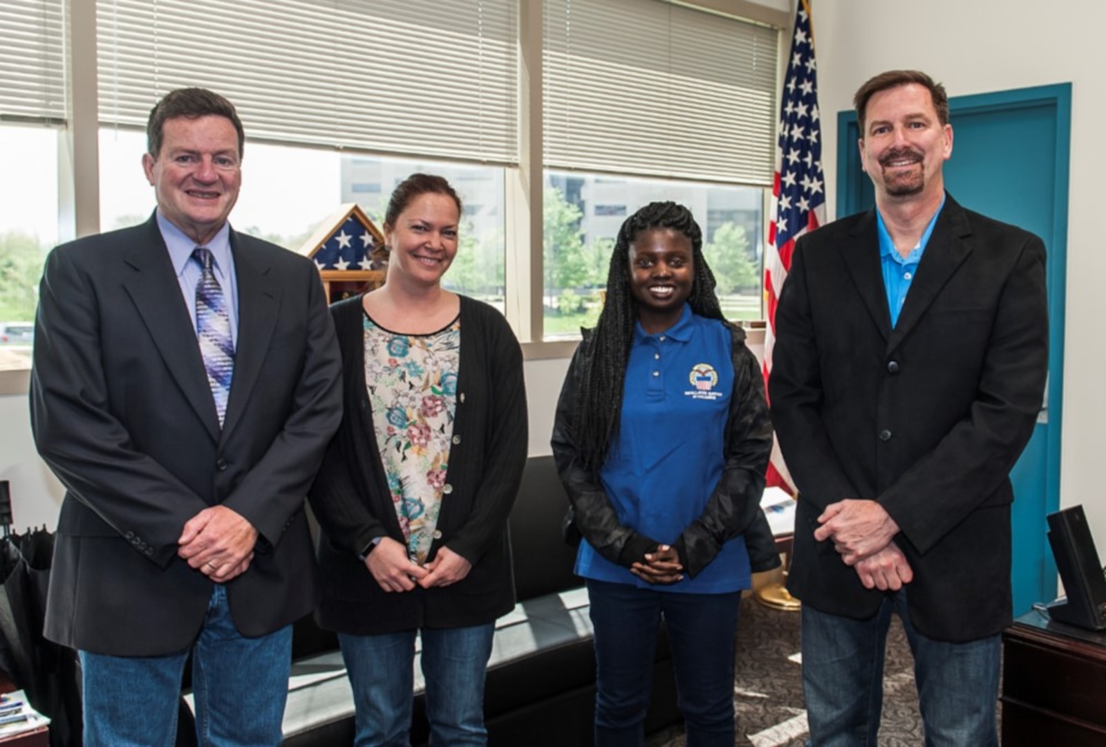 DSCC Site Director Dan Bell (left), Krista Litman, Michelle Bennett and DSCC Deputy Site Director Todd Jenkins (right) support sexual assault awareness during Denim Day on Apr. 26.