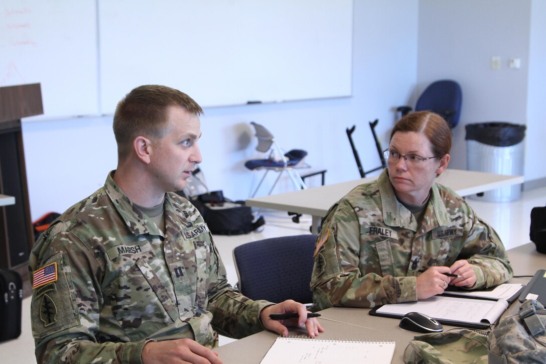 SEAGOVILLE, Texas - Capt. Tyler Marsh and Command Sgt. Maj. Lita Fraley, both from the 431st Civil Affairs Battalion out of Little Rock, Ark., discuss multiple courses of action to address their hypothetical emergency situation as part of the Defense Support of Civil Authorities workshop held here April 22-24, 2017. (U.S. Army Reserve photo by Spc. Christopher Hernandez, 345th Public Affairs Detachment)