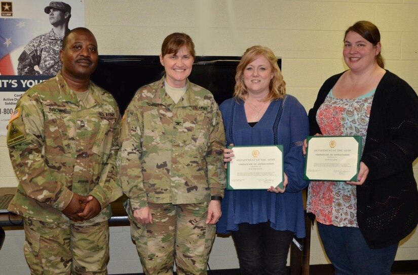 Col. Janet Townley, acting commander for the Army Reserve Sustainment Command, and Master Sgt. Douglas Brown, sexual harassment assault response and prevention non-commissioned officer for the ARSC’s Headquarters, Headquarters Company, present Heather Mahler, sexual assault nurse examiner, and Rhiannon Reese, clinical director of crisis programs at Crisis Inc., with certificates of appreciation for their time and information. 