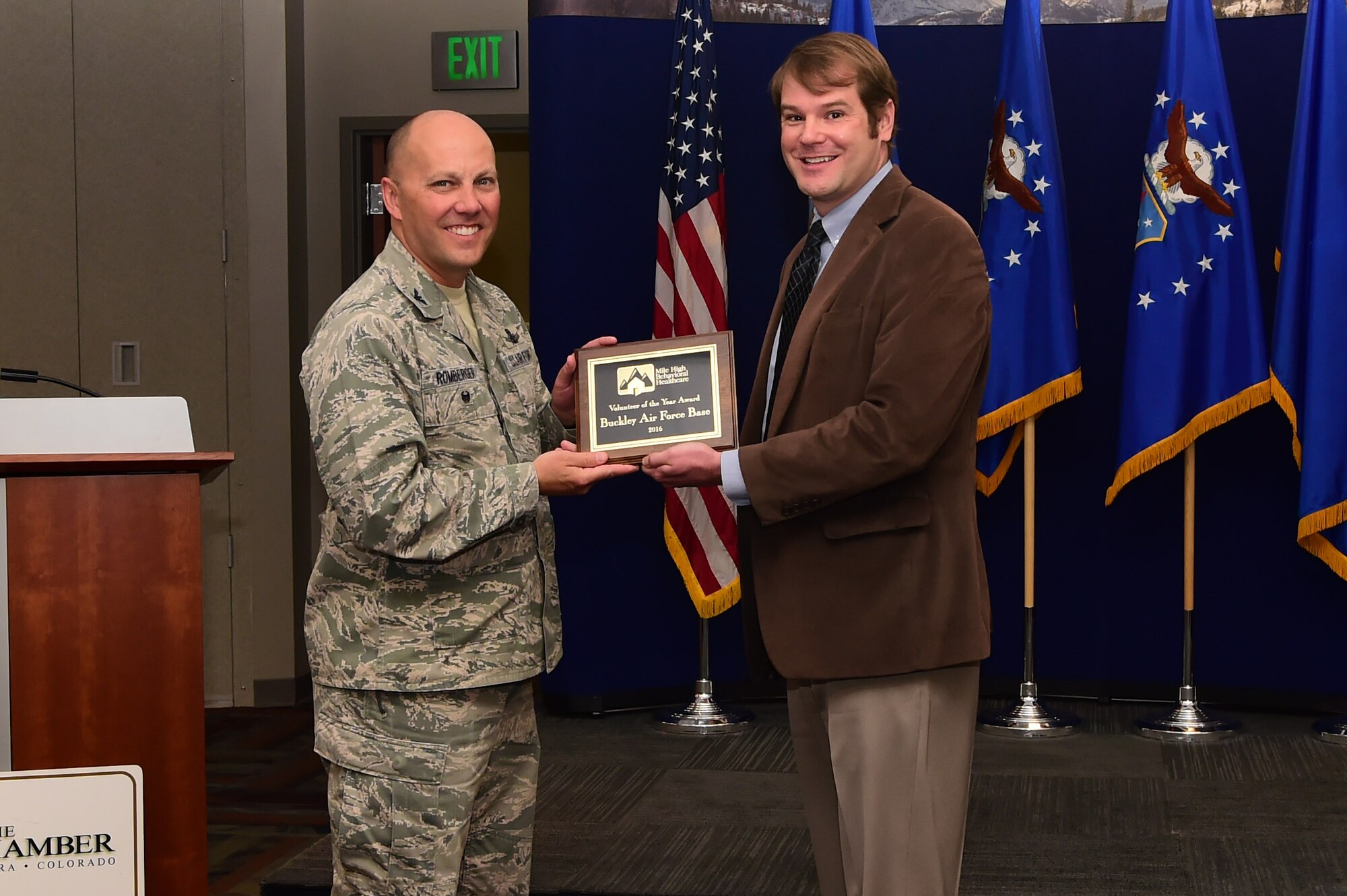 James Gillespie, director of development at Comitis Crisis Center, presents 460th Space Wing vice commander, Col. Scott Romberger, with the Volunteer of the Year Award on behalf of Buckley Air Force Base. Members of Team Buckley were cited for a collective contribution of over 350 hours to Comitis in 2016, including skilled and technical labor on capital improvement at the shelter. (U.S. Air Force photo by Airman 1st Class Jessica Huggins/released)