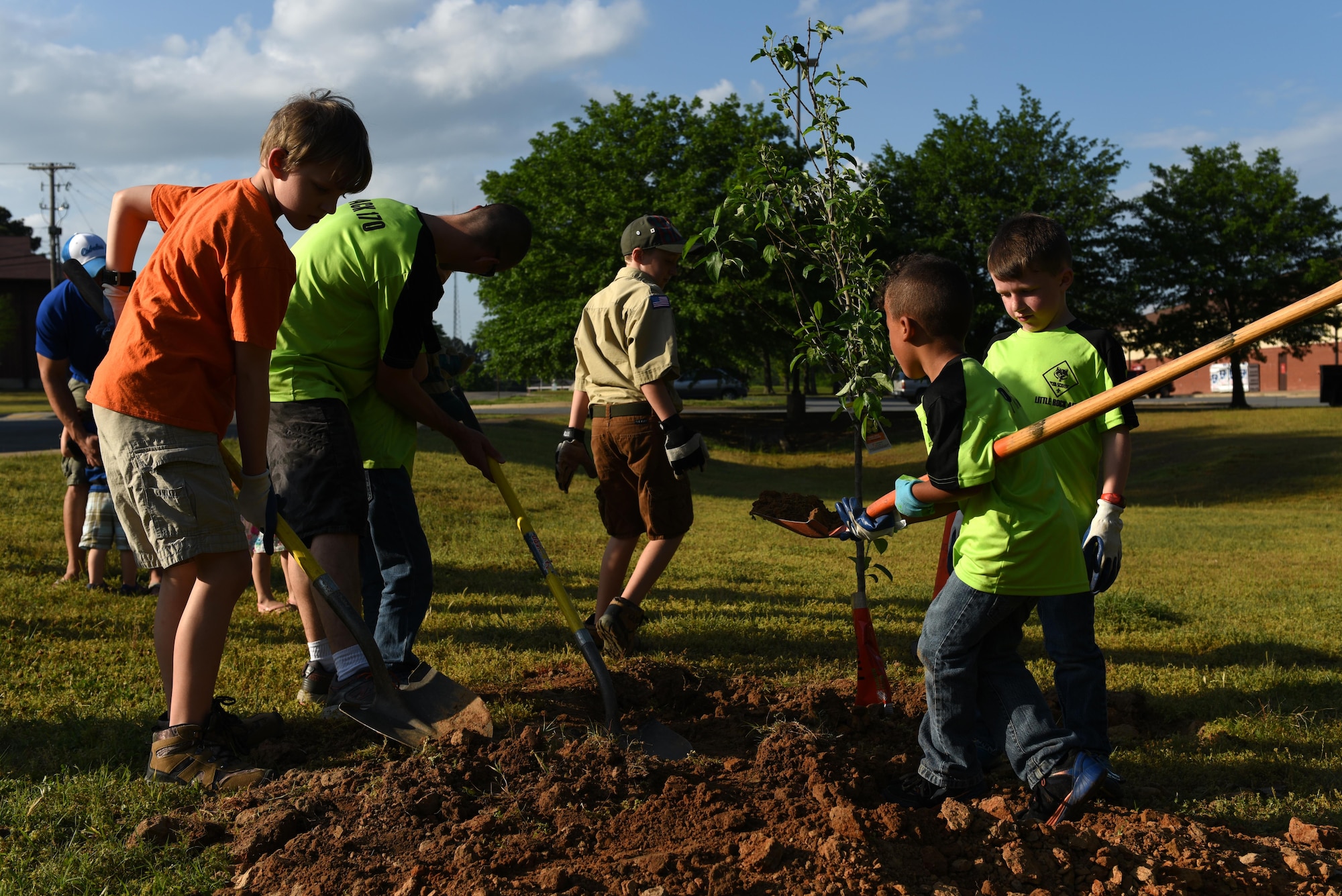 Cub Scouts Pack 170 plant a fruit tree April 19, 2017, near the Jacksonville Lighthouse Charter School: Flightline Upper Academy on Little Rock Air Force Base, Ark. Little Rock AFB continually partners with the community to maintain and plant its growing population of urban trees. (U.S. Air Force photo by Senior Airman Mercedes Taylor)