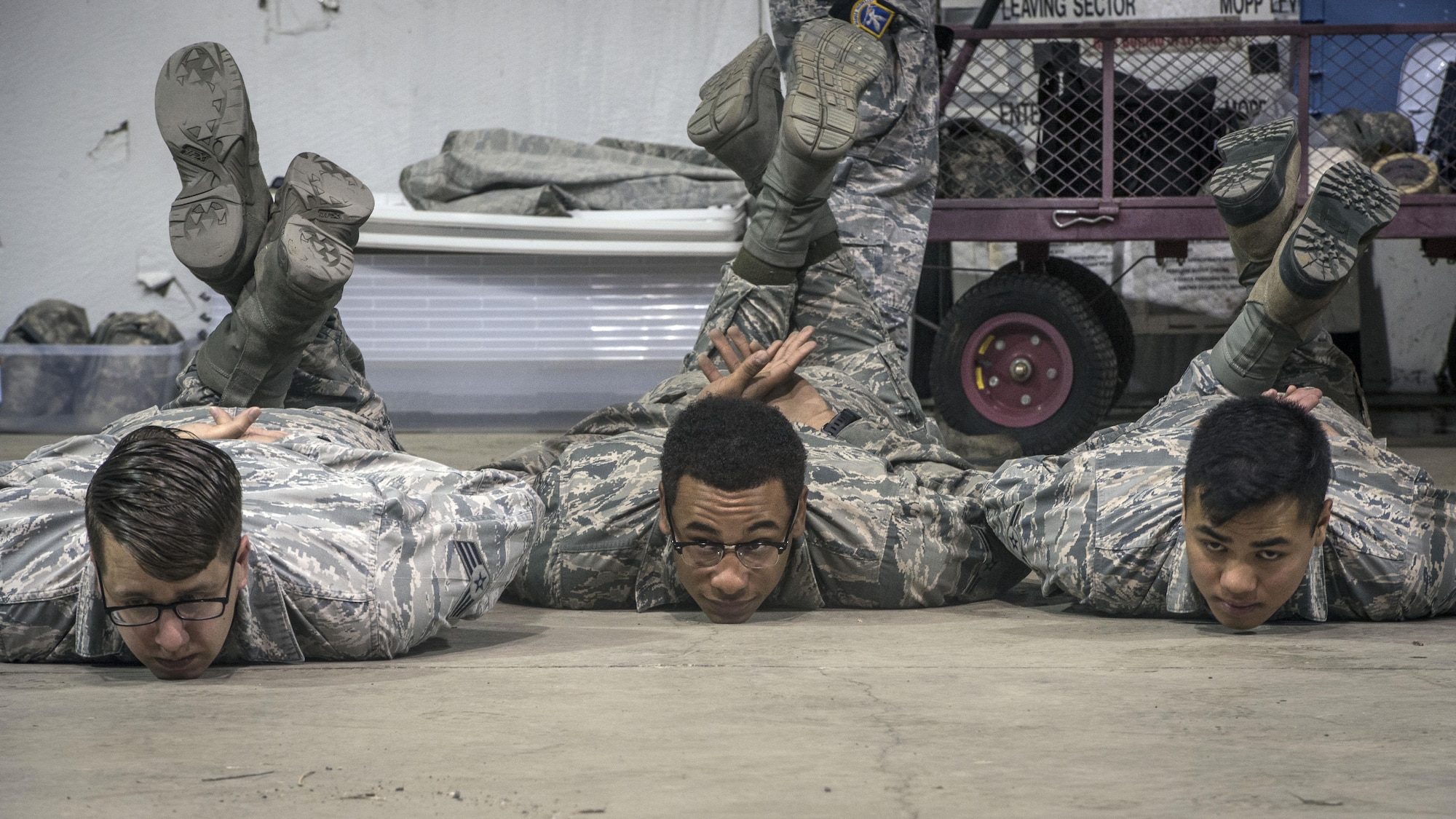 From the left, Senior Airman Alexander Sheridan, Airman 1st Class Dijon Edwards and Airman Vincent Duller, all 775th Civil Engineer Squadron, are detained as unknown individuals during an active shooter response exercise April 24 at Hill Air Force Base.  (U.S. Air Force/Paul Holcomb)