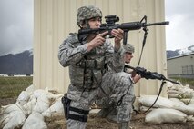 Senior Airman Dwight Gomes, foreground, and Staff Sgt. Jacob Sime, both 75th Security Forces Squadron, respond to a report of an active shooter and explosives during a response exercise at building 732, Hill Air Force Base, April 24. (U.S. Air Force/Paul Holcomb)