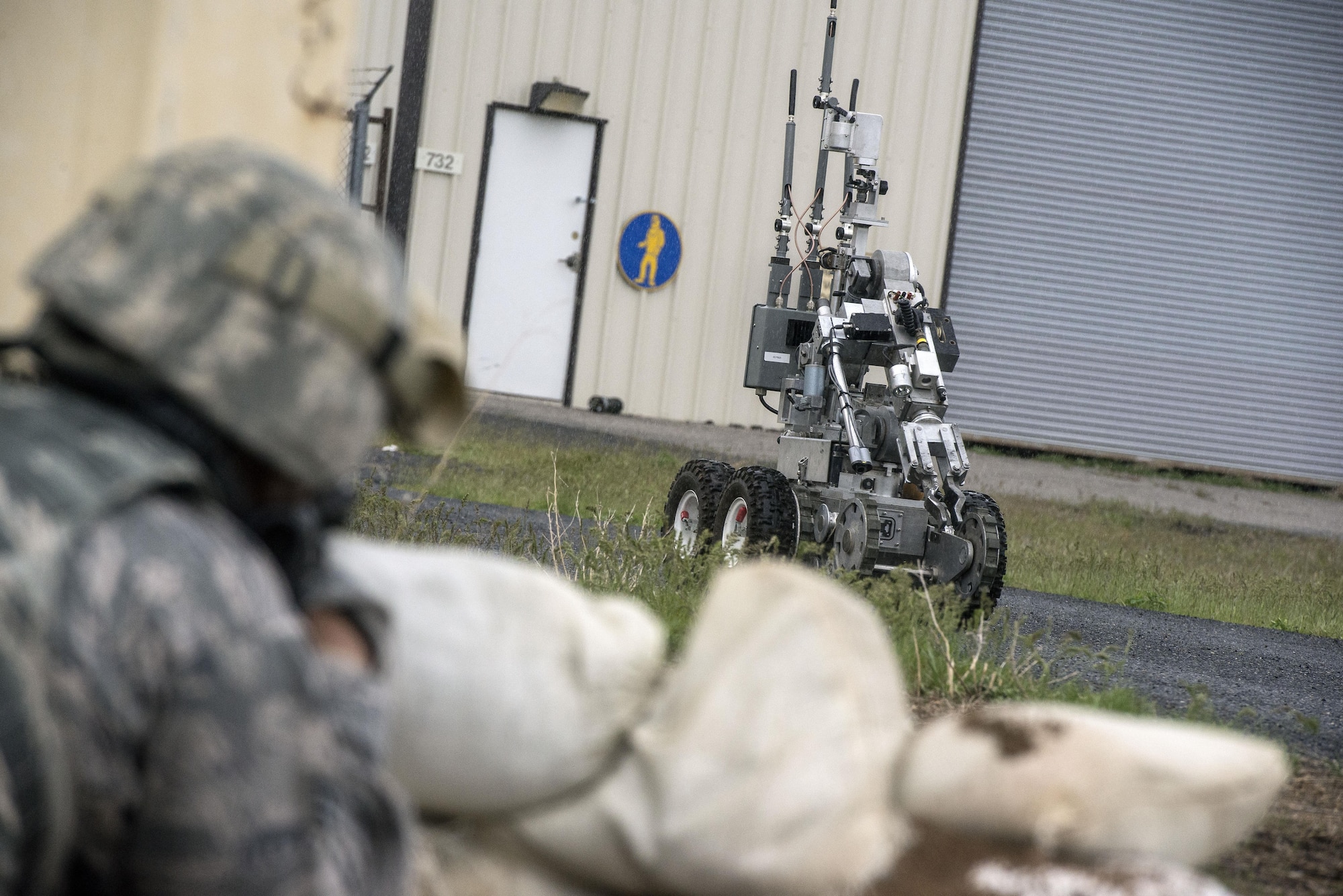 An Explosive Ordnance Disposal robot returns to the EOD response vehicle after inspecting a mock homemade device at the base of a door on the west side of building 732, Hill Air Force Base, April 24. Airmen from the 75th Security Forces Squadron and 775th EOD Flight participated in an active shooter and explosives response exercise. (U.S. Air Force/Paul Holcomb)