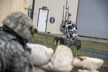 An Explosive Ordnance Disposal robot returns to the EOD response vehicle after inspecting a mock homemade device at the base of a door on the west side of building 732, Hill Air Force Base, April 24. Airmen from the 75th Security Forces Squadron and 775th EOD Flight participated in an active shooter and explosives response exercise. (U.S. Air Force/Paul Holcomb)