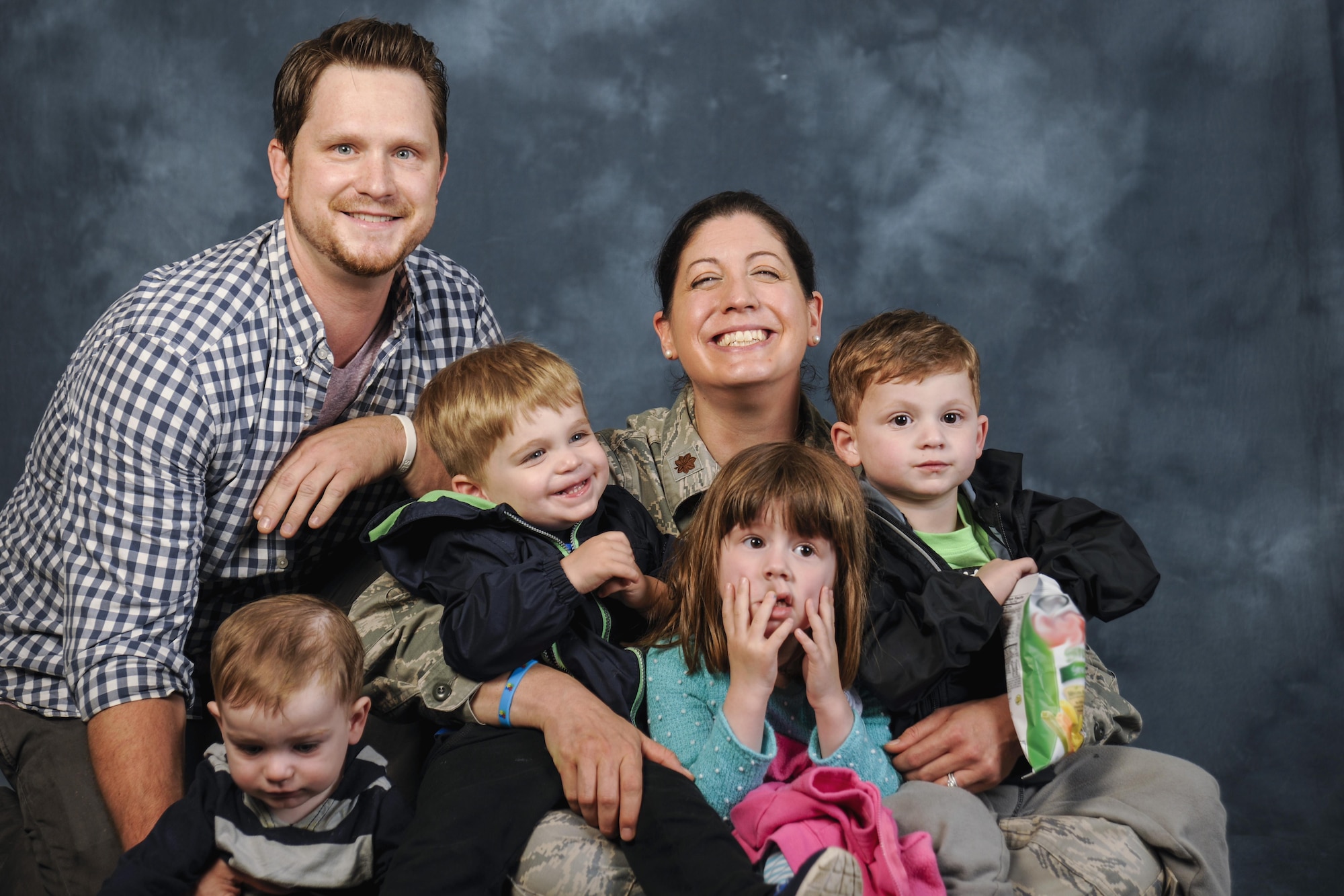 The Christi family poses for a photo at Joint Base Andrews, Md., April 27, 2017. Michael Christi, far right, son of Jeff Christi and Maj. Rebecca Christi, 799th Medical Group pediatrician, has autism spectrum disorder. The Air Force provides Michael with health and educational services, including Exceptional Family Member Program and Extended Care Health Options, which in turn provide therapies such as applied behavior analogy, speech therapy, and occupational therapy. April is also Autism Awareness Month, which is meant to increase understanding and acceptance of autism. (U.S. Air Force photo by Airman 1st Class Valentina Lopez)