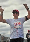 A runner gets sprayed with color during the Minot Meltdown color run at Minot Air Force Base, N.D., April 25, 2017. The purpose of the run was to raise awareness for alcohol abuse, child abuse and sexual assault. (U.S. Air Force photo/Senior Airman Apryl Hall)