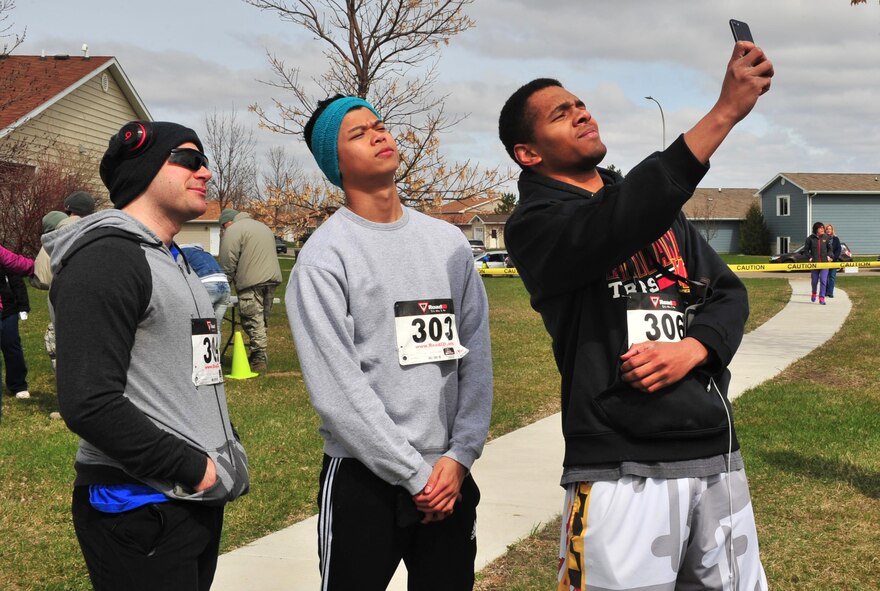 Participants take a “selfie” before the Minot Meltdown color run at Minot Air Force Base, N.D., April 25, 2017. The run was hosted by the Health and Wellness Center, Alcohol and Drug Abuse Prevention, Family Advocacy Program and Sexual Assault Prevention and Response Program. (U.S. Air Force photo/Senior Airman Apryl Hall)