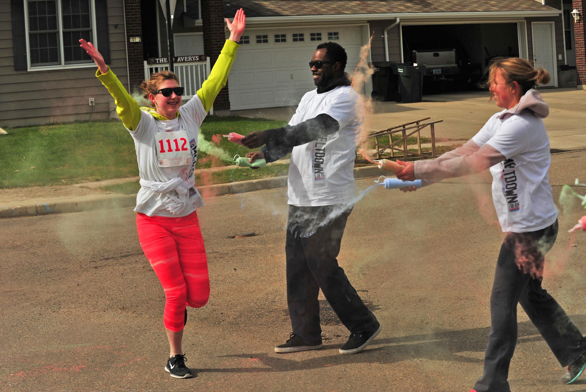 An enthusiastic runner gets sprayed by color during the Minot Meltdown color run at Minot Air Force Base, N.D., April 25, 2017. Runners had the option of running a 5K or 10K race. (U.S. Air Force photo/Senior Airman Apryl Hall)