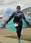 Tech. Sgt. Joshua Hull, 5th Maintenance Squadron crew chief, runs through a color station during the Minot Meltdown color run at Minot Air Force Base, N.D., April 25, 2017. This was the fourth annual color run hosted by the 5th Medical Group and Hull’s fourth time participating in it. (U.S. Air Force photo/Senior Airman Apryl Hall)