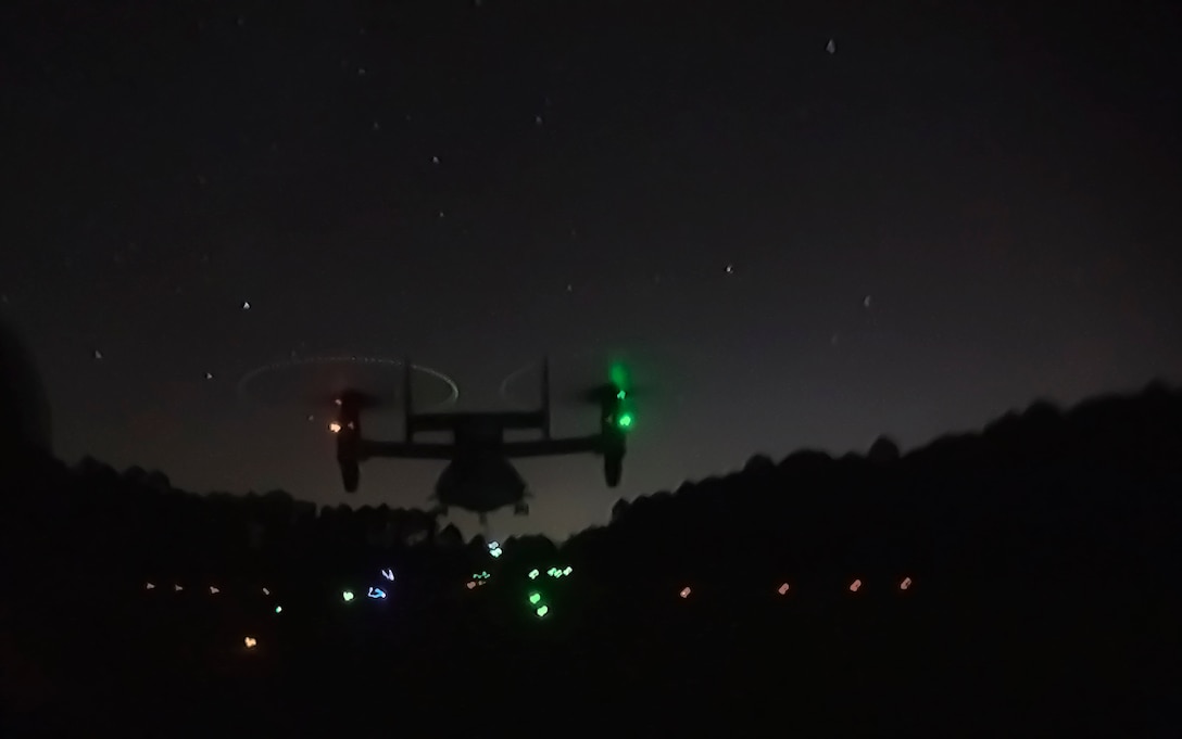 A MV-22B Osprey hovers over a landing zone while a helicopter support team attaches a load to the helicopter during an external lift exercise at Camp Lejeune, N.C., Jan. 24, 2017. External lifts provide a fast, effective way to move cargo and other heavy equipment, increasing the logistic capabilities of ground elements. The helicopter support team Marines are with Combat Logistics Battalion 26. (U.S. Marine Corps photo by Lance Cpl. Damarko Bones)