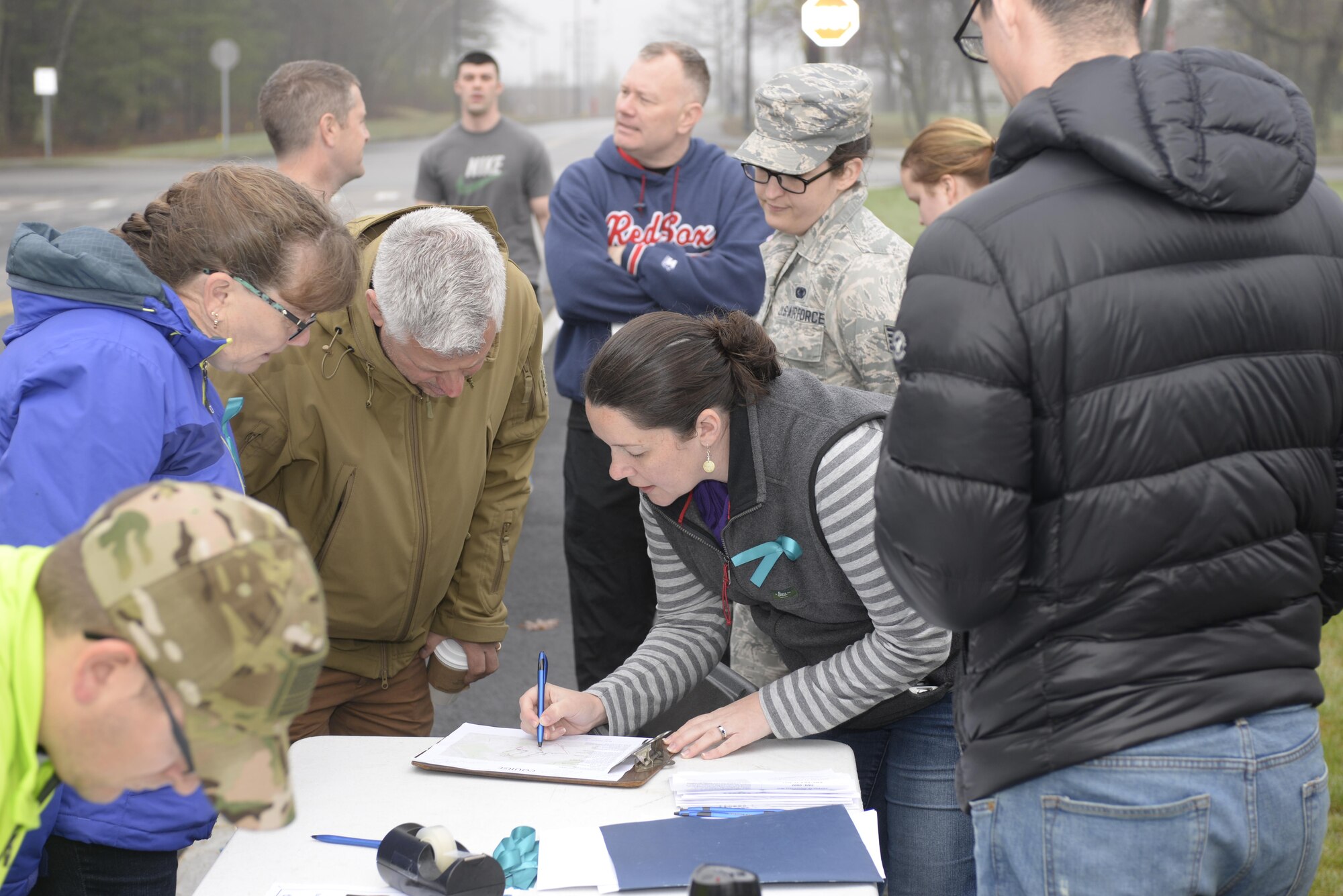 U.S. Air Force Major Moira Cuthbert, the sexual assault response coordinator from the 157th Air Refueling Wing, explains the Sexual Assault Awareness Prevention and Response 5K route to volunteers, Bonnie Rice, family program coordinator, Pease Air National Guard Base, Donald Roussel, director of psychological help, Pease ANGB, Staff Sgt. Kersten Arends, SAPR victim advocate, Pease ANGB, and U.S. Army Staff Sgt. Jeremy Poole, the state victim advocate for NHANG, prior to the start of the first SAPR 5K at Pease ANGB, hosted by members of the SAPR program at Pease ANGB, N.H. April 27, 2017.. (U.S. Air National Guard photo by Mast Sgt. Thomas Johnson)