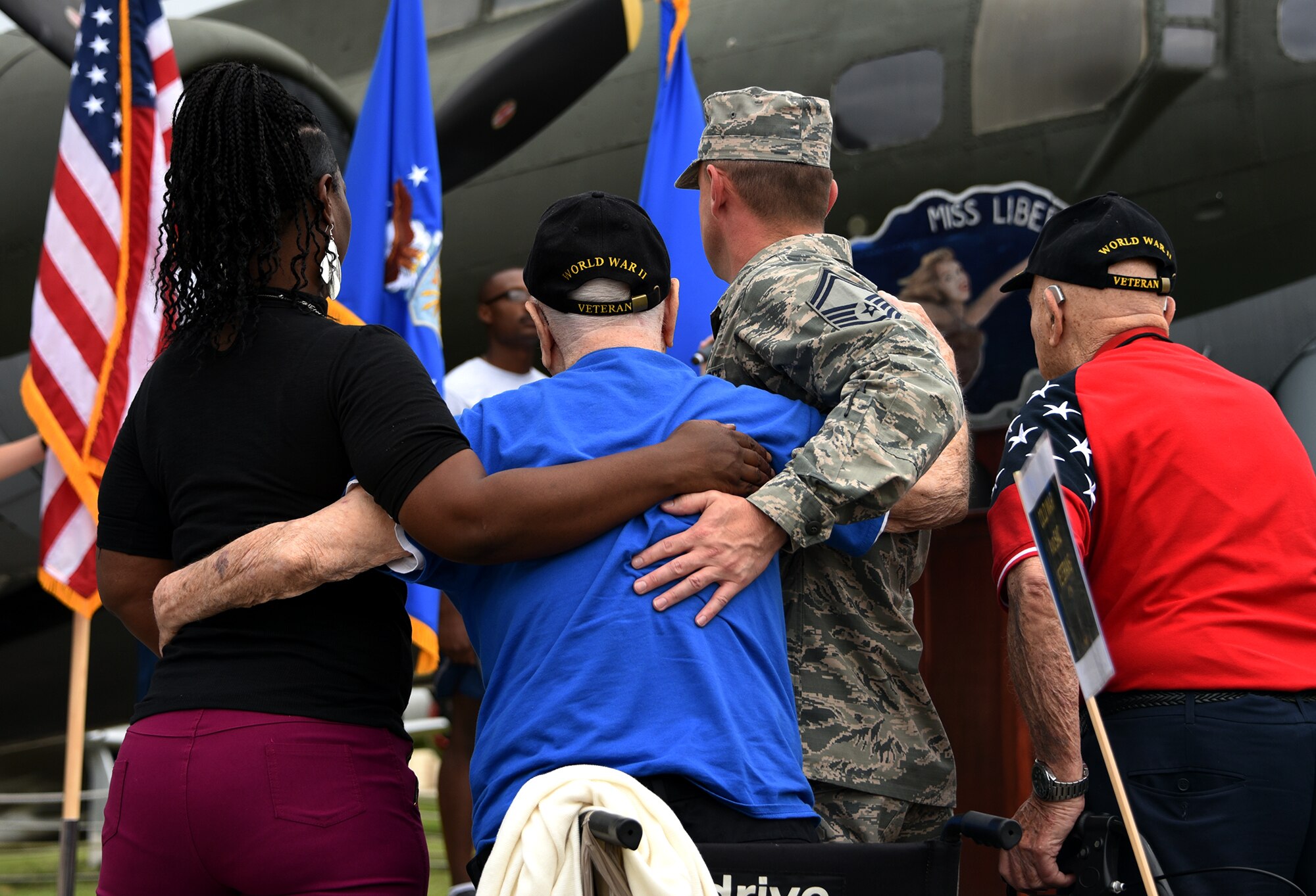 Retired Tech. Sgt. John Carpenter, Eighth Air Force World War II veteran, center, stands during the singing of the national anthem during a Mighty Eighth Heritage 8K held at Barksdale Air Force Base, La., April 26, 2017. Approximately 100 Airmen and their family members ran in honor of Eighth Air Force veterans as a way of recognizing and remembering the services and sacrifices they made for their country. The run served as one of the many events held in commemoration of the Eighth Air Force’s 75th anniversary. (U.S. Air Force photo by Senior Airman Erin Trower) 