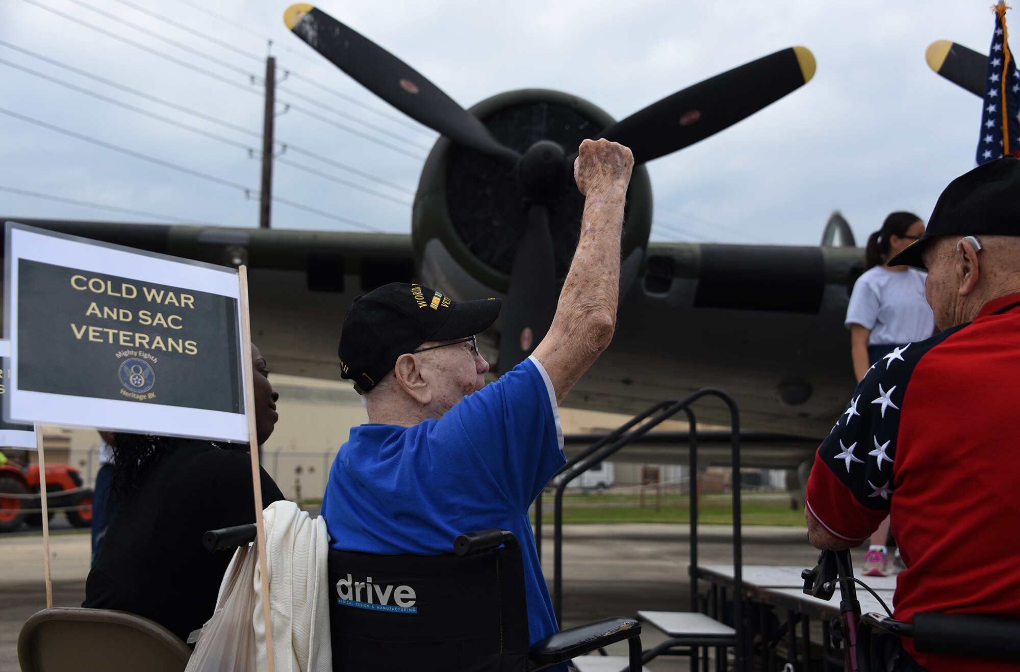 Retired Tech. Sgt. John Carpenter, Eighth Air Force World War II veteran, raises his hand during a roll call that took place as part of the Mighty Eighth Heritage 8K event at Barksdale Air Force Base, La., April 26, 2017. During combat, aviators did not always have radios to check in with the service members, and a roll call would be taken at the end of the day to determine who did not make it back from a mission. During the heritage event, the roll call symbolized who did return back from the operations they participated in. (U.S. Air Force photo by Senior Airman Erin Trower)