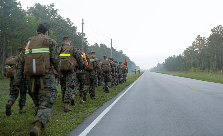 Marines conduct a six mile hike at Camp Lejeune, N.C., April 27, 2017. The hike is essential for preparing Marines and sailors for future combat missions and promotes unit cohesion. The Marines are with the II Marine Expeditionary Force Headquarters group. (Photo by Lance Cpl. Leynard Kyle Plazo)