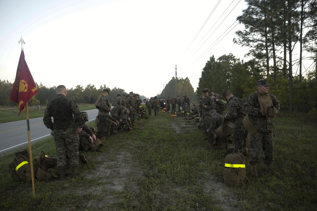 Marines conduct a 10 minute break at the halfway point of a six mile hike at Camp Lejeune, N.C., April 27, 2017. The hike is essential for preparing Marines and Sailors for future combat missions and promotes unit cohesion. The Marines are with the II Marine Expeditionary Force Headquarters group. (Photo by Lance Cpl. Leynard Kyle Plazo)