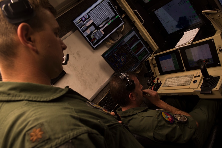Maj. Aaron, a 29th Attack Squadron MQ-9 Reaper instructor pilot, left, instructs Maj. Jaime, a Spanish air force student pilot, on the MQ-9 procedures at Holloman Air Force Base, NM on April 19, 2017. Spain is currently participating in essential training here at the MQ-9 formal training unit. (U.S. Air Force photo by Tech. Sgt. Amanda Junk)