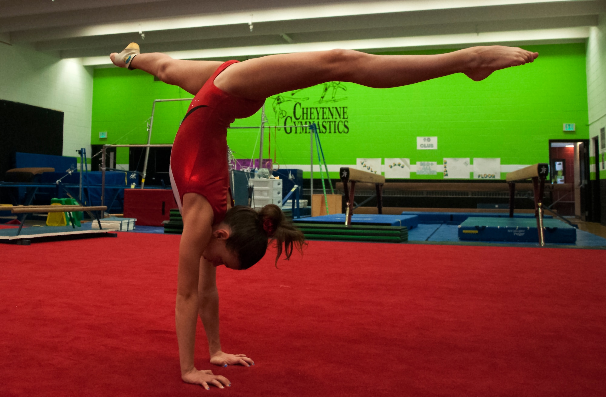 Emma Brittingham, daughter of Lt. Col. Jake Brittingham, 23rd Flying Training Squadron, does a split handstand April 2, 2016, in Cheyenne, Wyo. The Brittingham family uses Emma’s gymansitcs training as a way to integrate into communities they move to. (U.S. Air Force photo by Senior Airman Brandon Valle)