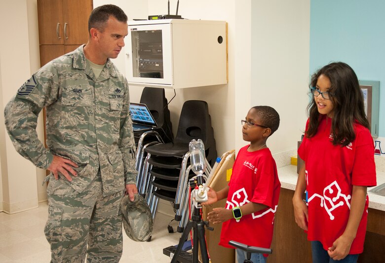 Master. Sgt. Jeffrey Allen, 96th Force Support Squadron first sergeant, and youth center members test new science equipment in the youth center’s Center of Innovation April 20, 2017. (U.S. Air Force photo/Sara Francis)