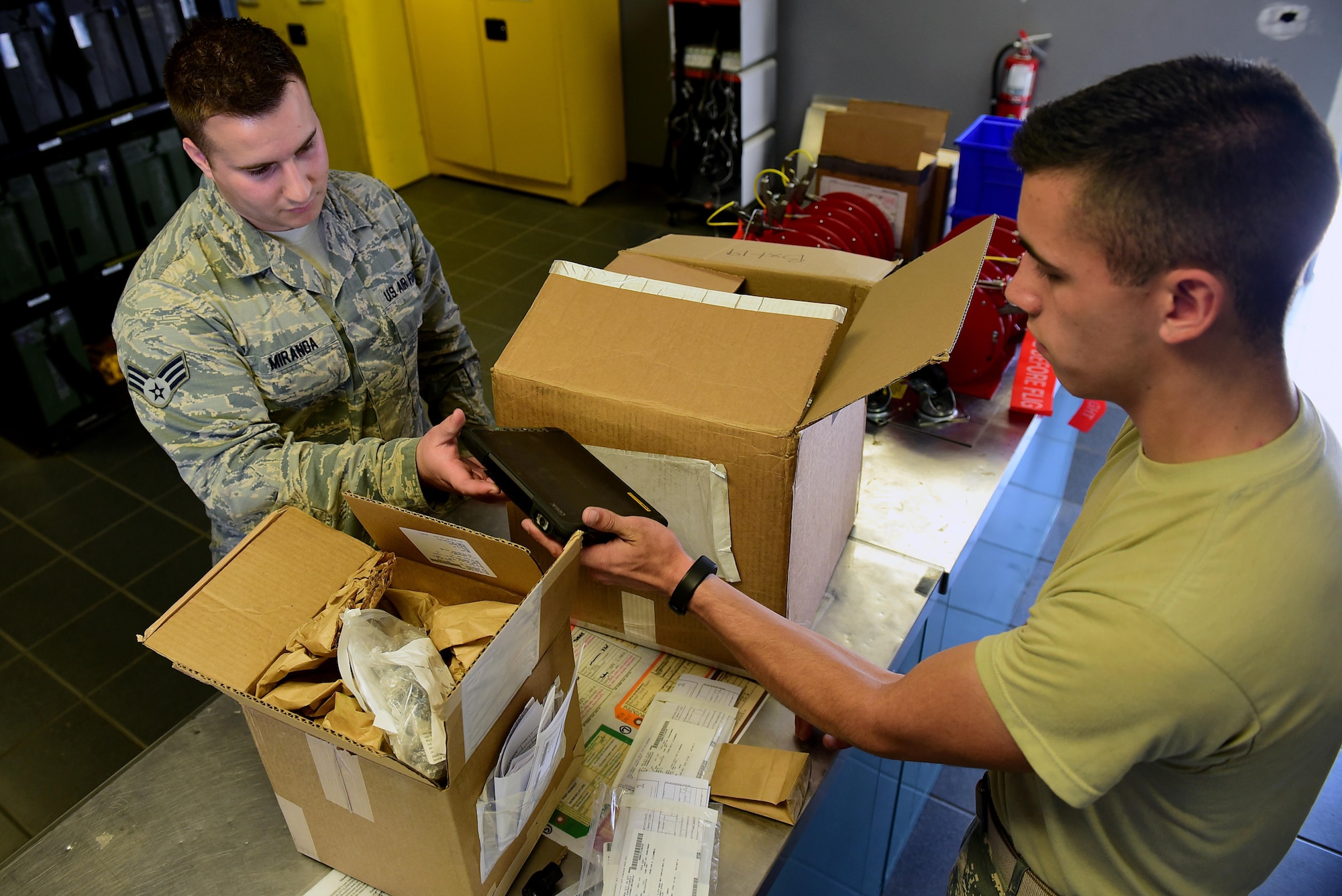 Senior Airman Kevin Miranda, 4th Component Maintenance Squadron aircraft fuel systems journeyman (left), signs for parts April 27, 2017, at Seymour Johnson Air Force Base, North Carolina. Airman 1st Class Brandon Ferguson, 4th Logistics Readiness Squadron driver (right), delivers an average of 200 parts per day across base. (U.S. Air Force photo by Airman 1st Class Kenneth Boyton)