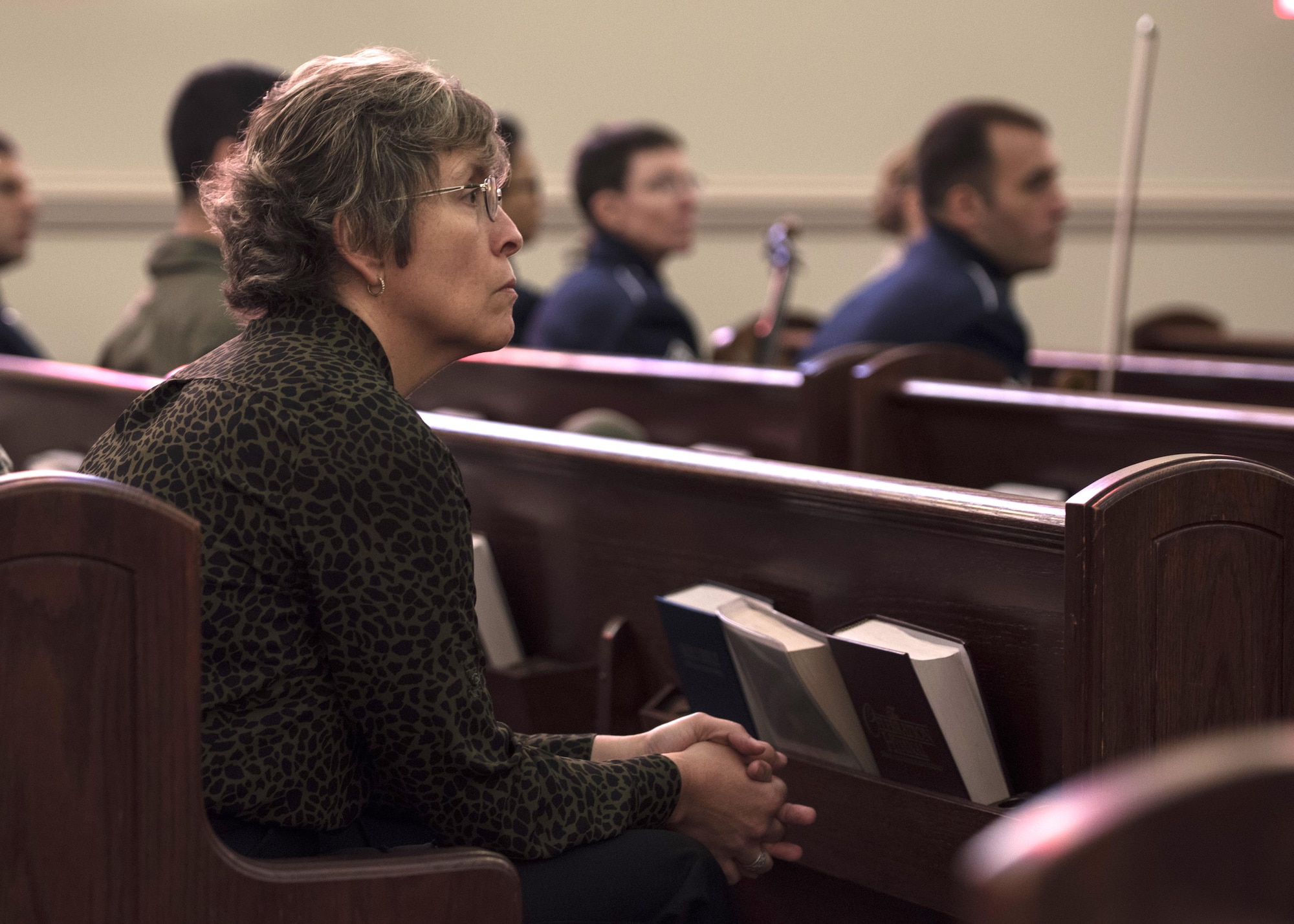 An audience member listens to Dr. Alfred Münzer, Holocaust survivor, speak during the Holocaust Commemoration at Joint Base Andrews, Md., April 26, 2017. During the Holocaust and separation from his family, Münzer was cared for by a Dutch-Indonesian family. He was eventually reunited with his mother and the two subsequently moved to the U.S. (U.S. Air Force photo by Senior Airman Jordyn Fetter)