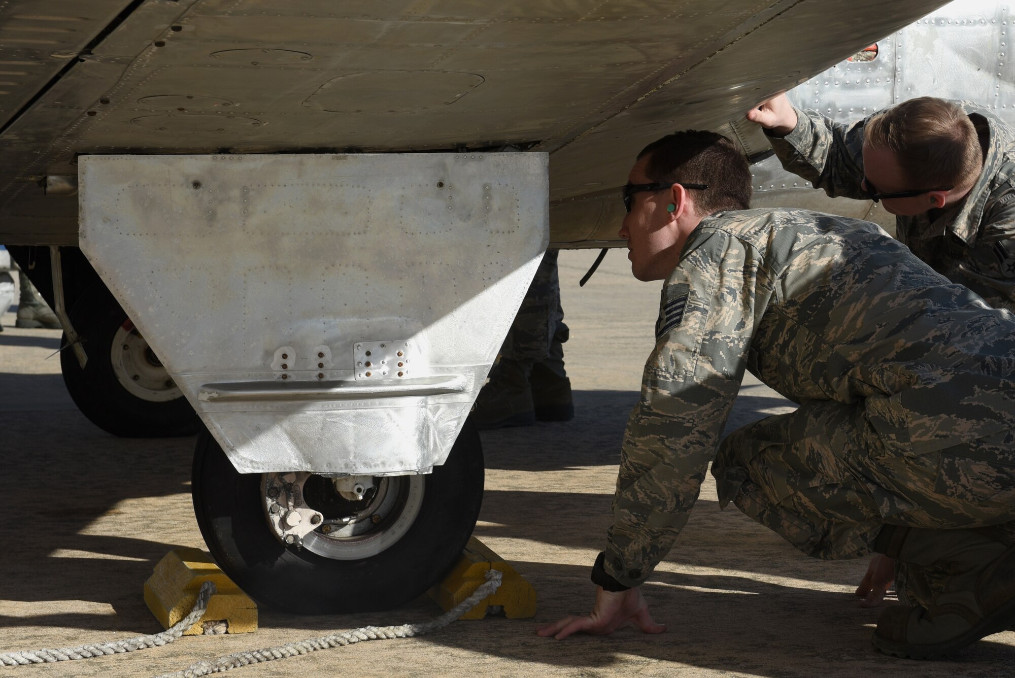 Members from the 4th Equipment Maintenance Squadron corrosion control shop inspect an unpainted T-34C Turbo Mentor, April 10, 2017, at Seymour Johnson Air Force Base, North Carolina. Members of 4 EMS painted two T-34C Turbo Mentors for the North Carolina Forest Service aviation division. (U.S. Air Force photo by Airman 1st Class Victoria Boyton)