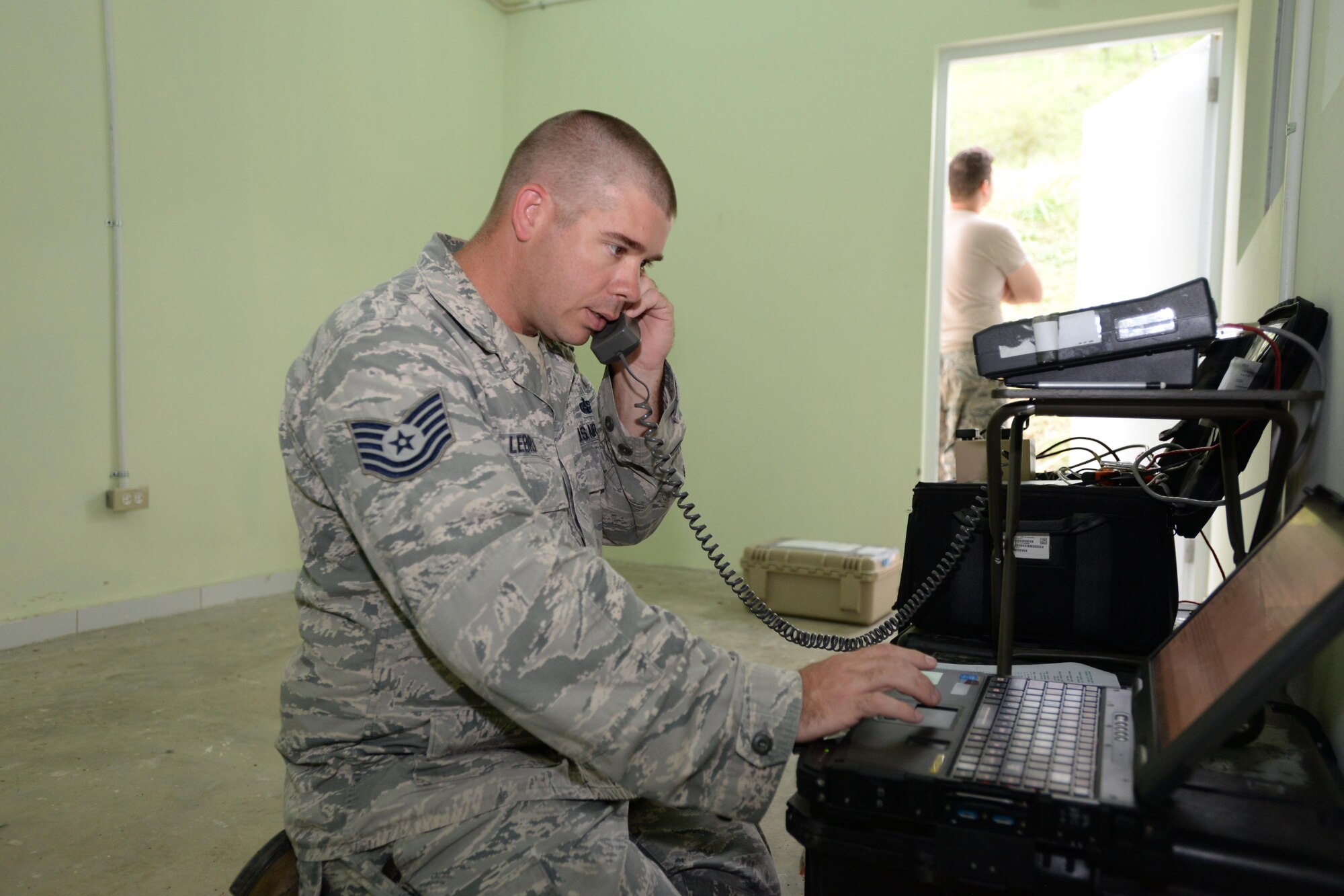 U.S. Air Force Tech. Sgt. Philippe LeBrun, the 51st Combat Communications Squadron (CCS) radio frequency transmission systems noncommissioned officer in charge, out of Robins Air Force Base, Ga., works on a computer in support of NEW HORIZONS 2017 in Arroyo Cano, Dominican Republic, April 24, 2017. Airmen with the 51st CCS train to provide the initial communications for a bare base setup such as the one used by U.S. service members during NH17. (U.S. Air Force photo by Staff Sgt. Timothy M. Young)