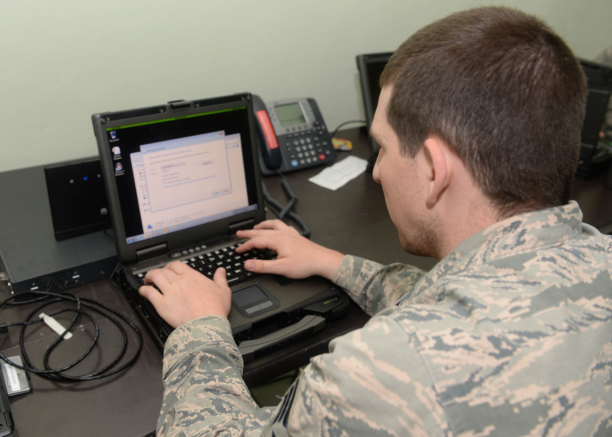 U.S. Air Force Senior Airman Joshua Marsh, a cyber systems operator with the 51st Combat Communications Squadron out of Robins Air Force Base, Ga., fixes a software problem on a government laptop during NEW HORIZONS 2017 in Arroyo Cano, Dominican Republic, April 13, 2017. Both software and hardware must be properly maintained in order to stay fully operational. (U.S. Air Force photo by Staff Sgt. Timothy M. Young)
