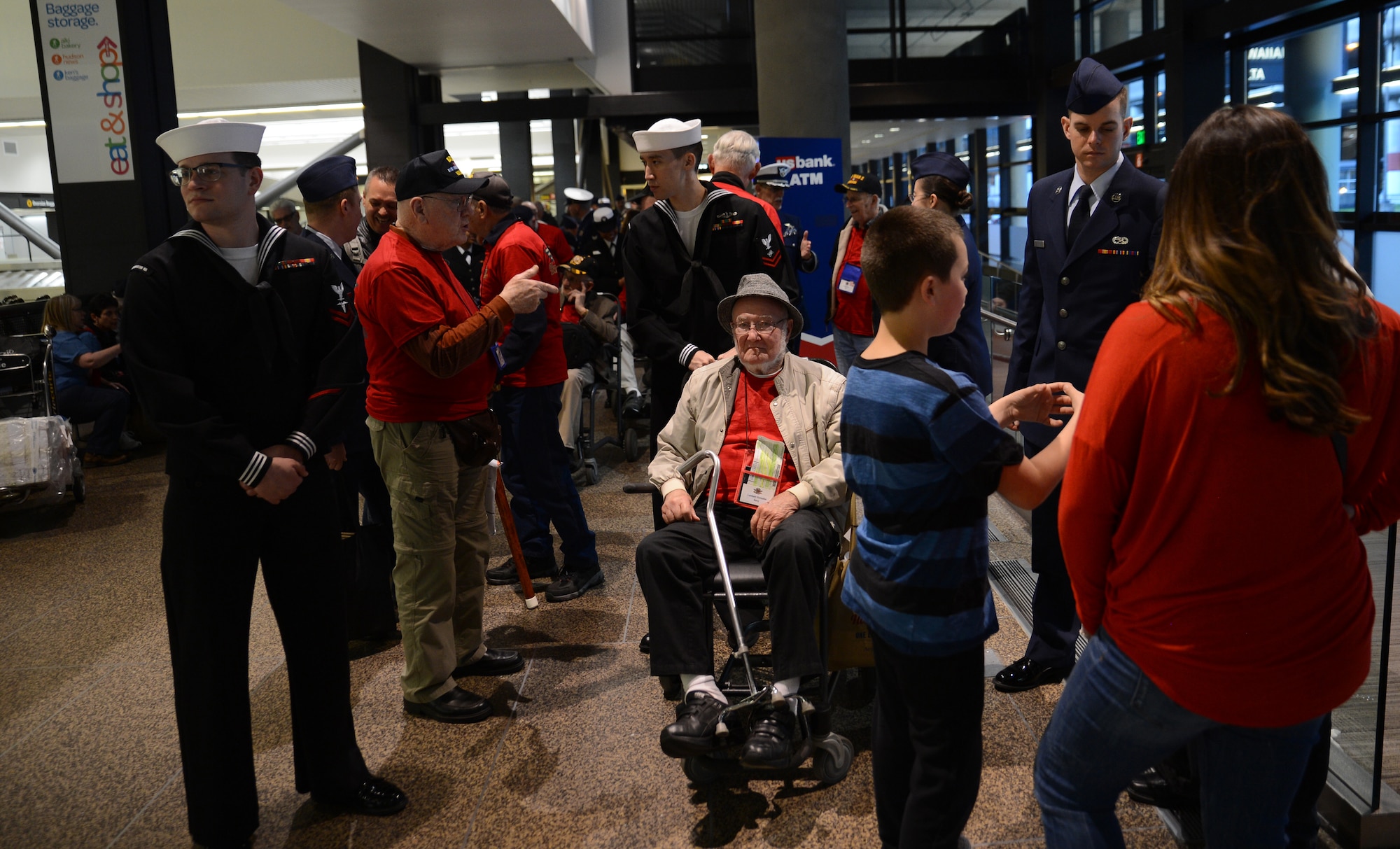 Service members entertain veterans participating in the Puget Sound Honor Flight April 24, 2017, at Seattle-Tacoma International Airport Seattle, Wash. The veterans were welcomed home after returning from their trip to Washington, District of Columbia to see monuments built in their honor, such as the World War II Memorial. (U. S. Air Force photo/Senior Airman Jacob Jimenez)   