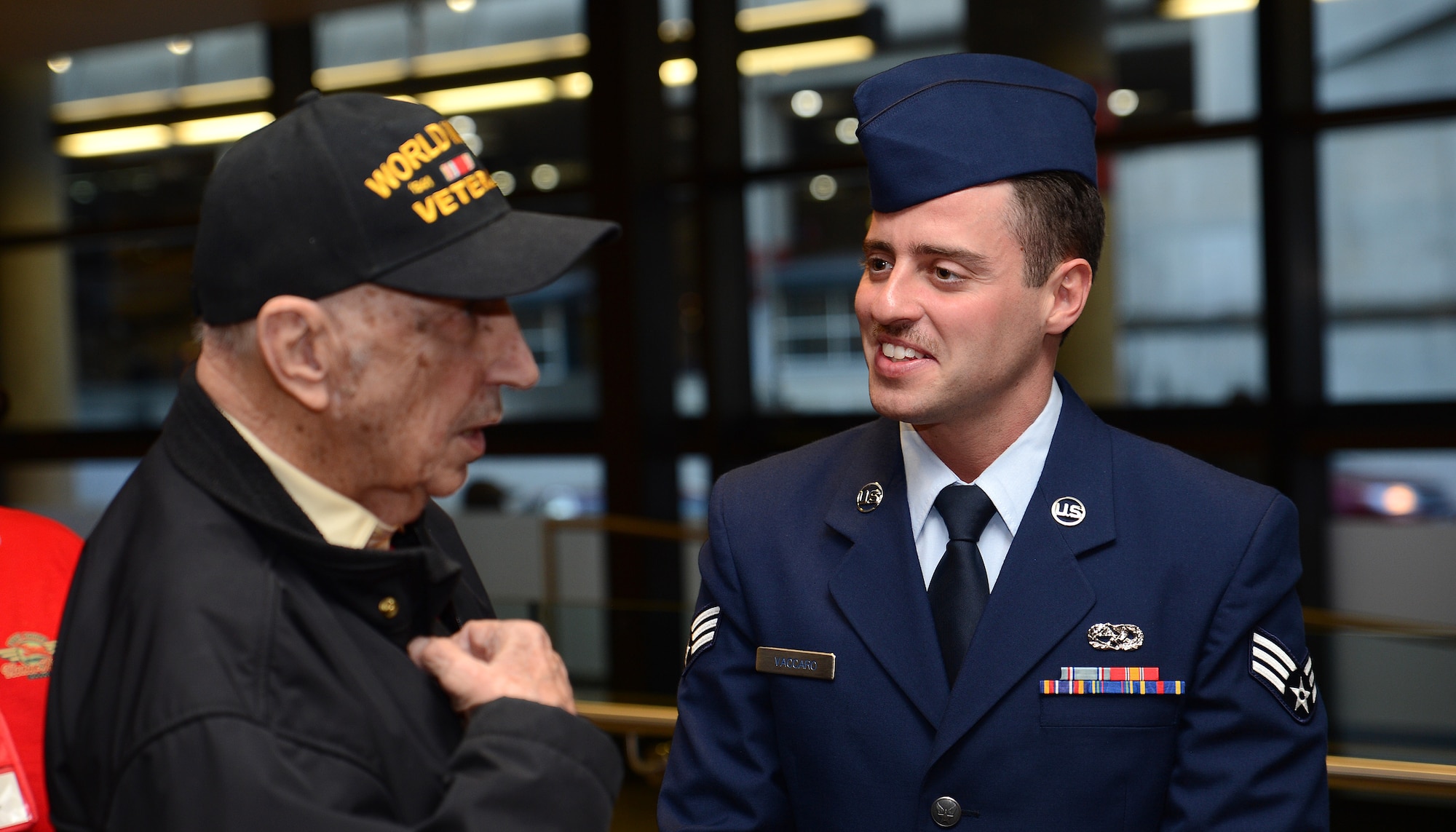 Senior Airman Nino Vaccaro, 62nd Maintenance Squadron aerospace propulsions specialist, entertains a local World War II veteran taking part in the Puget Sound Honor Flight April 24, 2017, at Seattle-Tacoma International Airport Seattle, Wash. The event is one of four done annually by the Puget Sound Honor Flight, a nonprofit organization founded to serve U.S. Veterans. (U.S. Air Force photo/Senior Airman Jacob Jimenez) 