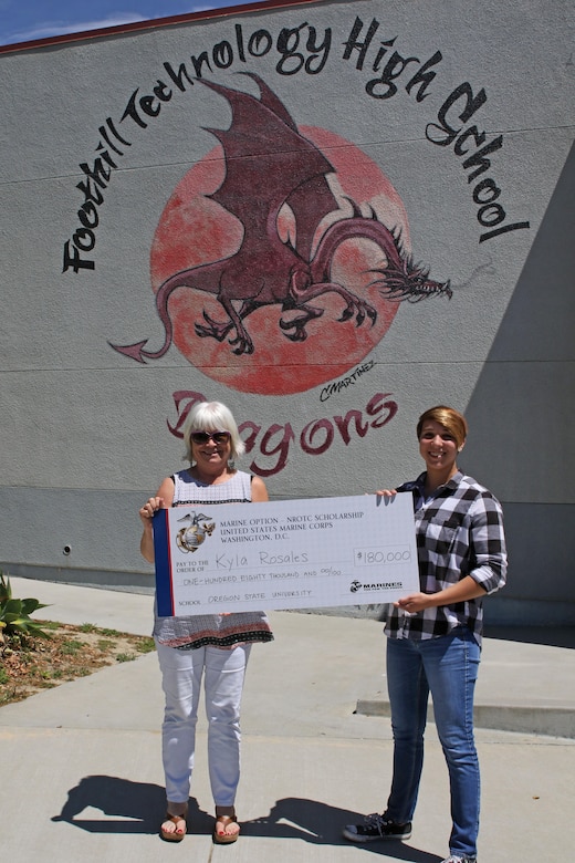 Foothill Technology High School’s Registrar Kris Nordin and student Kyla Rosales pose for a photo after Sergeant Brian Robert, recruiter of Recruiting Sub Station Ventura, presented a Naval Reserve Officers Training Corps Scholarship check to Kyla at the high school, April 26, 2017. “I am very proud of her achievement,” said Nordin. (U.S. Marine Corps photo by Staff Sgt. Alicia R. Leaders/Released)