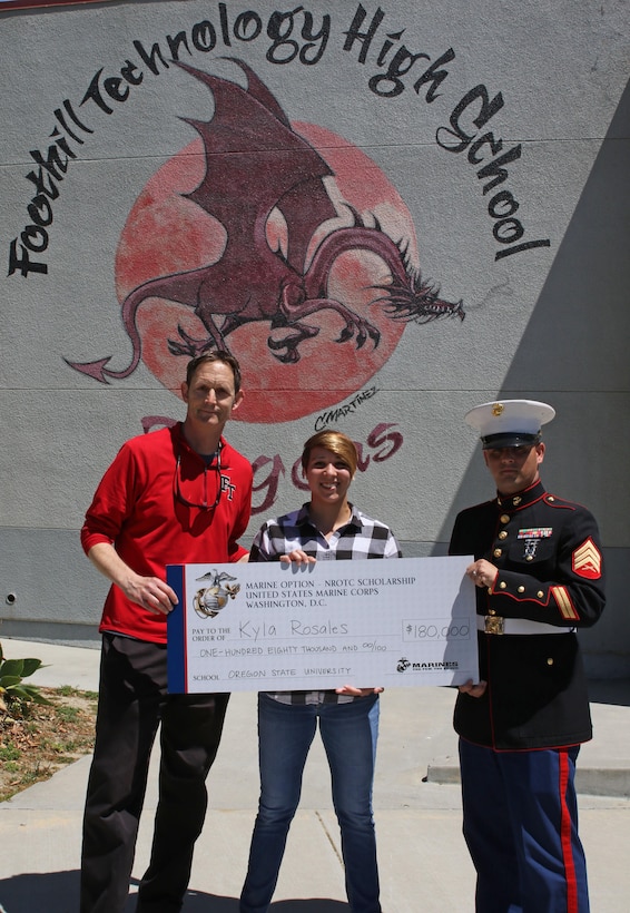 Foothill Technology High School Principal Joe Bova, and Sergeant Brian Robert, recruiter of Recruiting Sub Station Ventura, present a Naval Reserve Officers Training Corps Scholarship check to Kyla Rosales at Foothill Technology High School in Ventura, Calif., April 26, 2017. (U.S. Marine Corps photo by Staff Sgt. Alicia R. Leaders/Released)