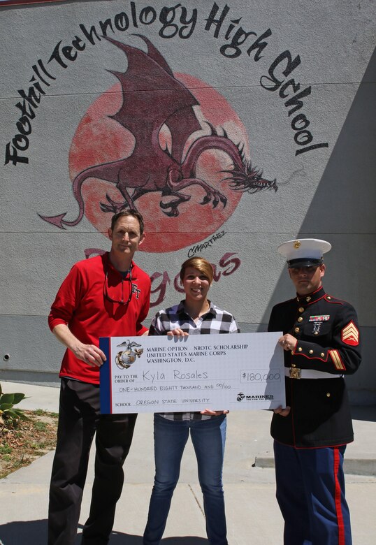 Foothill Technology High School Principal Joe Bova, and Sergeant Brian Robert, recruiter of Recruiting Sub Station Ventura, present a Naval Reserve Officers Training Corps Scholarship check to Kyla Rosales at Foothill Technology High School in Ventura, Calif., April 26, 2017. (U.S. Marine Corps photo by Staff Sgt. Alicia R. Leaders/Released)