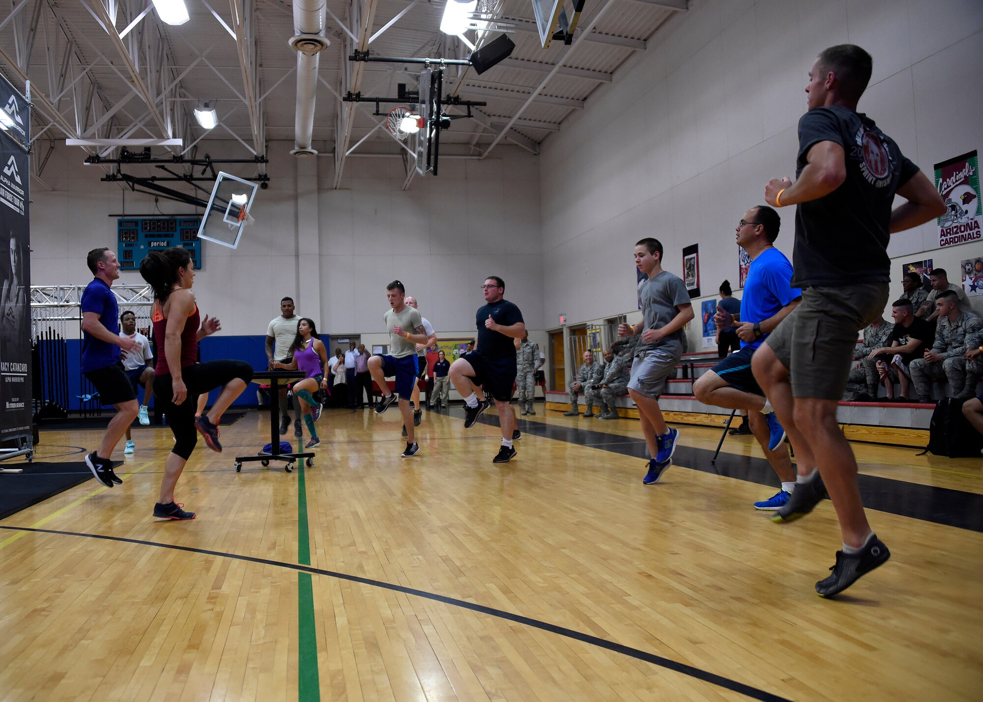 Luke Airmen and Alpha Warrior instructors warm-up before starting the obstacle course during the Alpha Warrior competition April 27, 2017, at Luke Air Force Base, Ariz. The Alpha Warrior program provides a new way for Airmen to work out, build unit cohesion, and encourage a sense of community within Airmen and families. (U.S. Air Force photo by Senior Airman Devante Williams) 