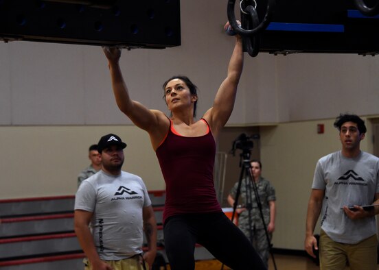 Rebekah Bonilla, Alpha Warrior pro warrior, demonstrates how to complete the obstacle course during the Alpha Warrior competition April 27, 2017, at Luke Air Force Base, Ariz. The Alpha Warrior program incorporates the four domains of Comprehensive Airman Fitness- physical, mental, social and spiritual-to achieve readiness and resilience at home and while deployed.  (U.S. Air Force photo by Senior Airman Devante Williams)