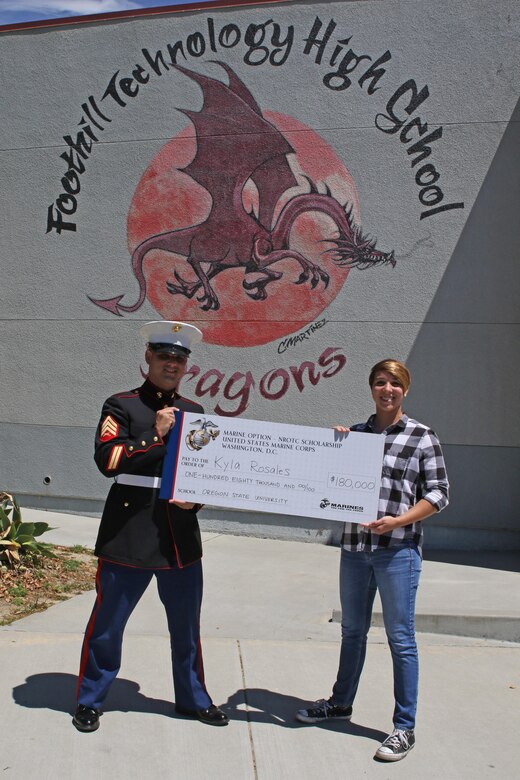 Sergeant Brian Robert, recruiter of Recruiting Sub Station Ventura, presents a Naval Reserve Officers Training Corps Scholarship check to Kyla Rosales at Foothill Technology High School in Ventura, Calif., April 26, 2017. The NROTC scholarship, valued at up to $180,000, will pay for the cost of full tuition, books and other educational fees at many of the country’s leading colleges and universities. (U.S. Marine Corps photo by Staff Sgt. Alicia R. Leaders/Released)