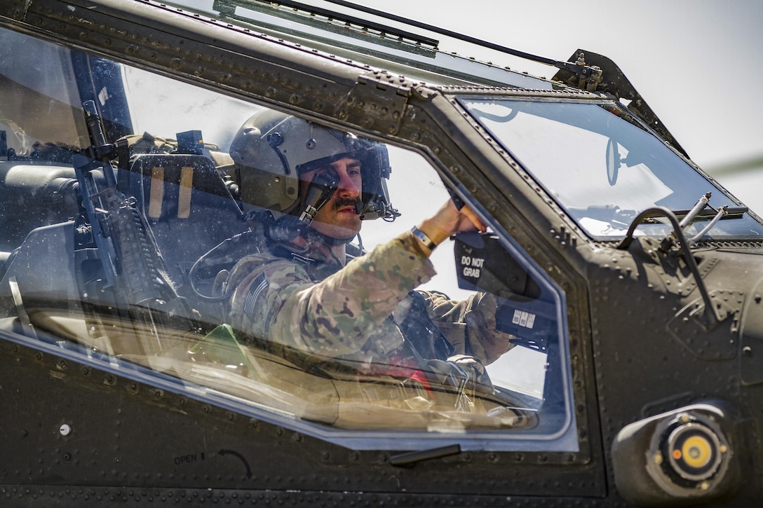 An Army AH-64E Apache helicopter pilot prepares to depart for a mission from Jalalabad Airfield, Afghanistan, April 25, 2017. The pilot is assigned to Task Force Tigershark. Army photo by Capt. Brian Harris