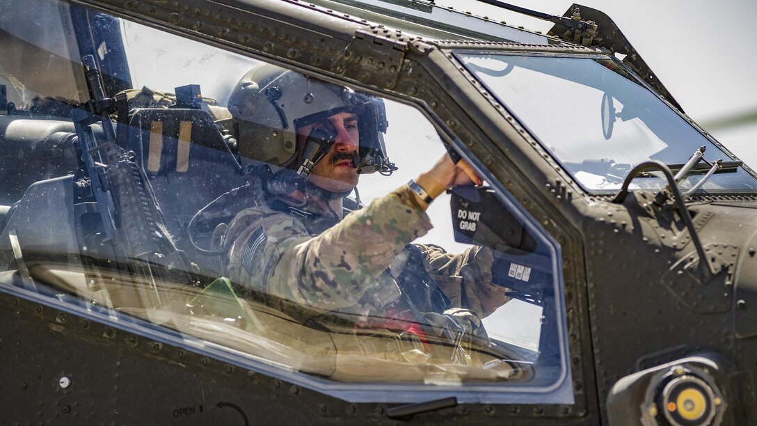 An Army AH-64E Apache helicopter pilot prepares to depart for a mission from Jalalabad Airfield, Afghanistan, April 25, 2017. The pilot is assigned to Task Force Tigershark. Army photo by Capt. Brian Harris