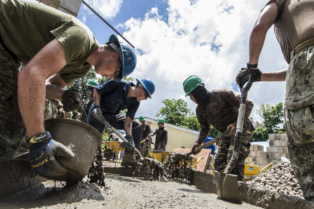 U.S. Marines and Philippine soldiers haul buckets of concrete to build a new school building in Ormoc, Philippines, April 24, 2017, as part of exercise Balikatan. The annual U.S.-Philippine exercise focuses on humanitarian assistance, disaster relief and counterterrorism. Navy photo by Petty Officer 2nd Class Markus Castaneda