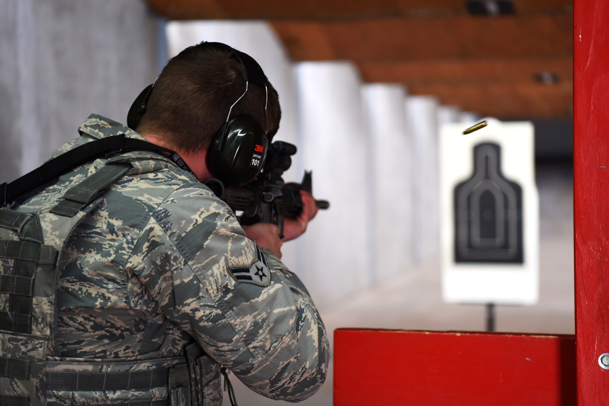 Airman 1st Class Nicholas Rauch, 460th Security Forces Squadron member, participates in the weapons qualification portion of the Emergency Services Team tryouts, March 10, 2017, on Buckley Air Force Base, Colo. The tryouts consisted of a timed obstacle course, an interview and a weapons qualification. The course was made up of a half-mile uphill run, followed by dragging a 90-pound dummy 50 meters, then sprinting about 100 meters where a jammed door needed to be  opened using a battering ram, and finally each contestant finished with five burpees. This was all completed while wearing gear that weighed roughly 40 pounds. (U.S. Air Force photo by Airman 1st Class Holden S. Faul/ Released)