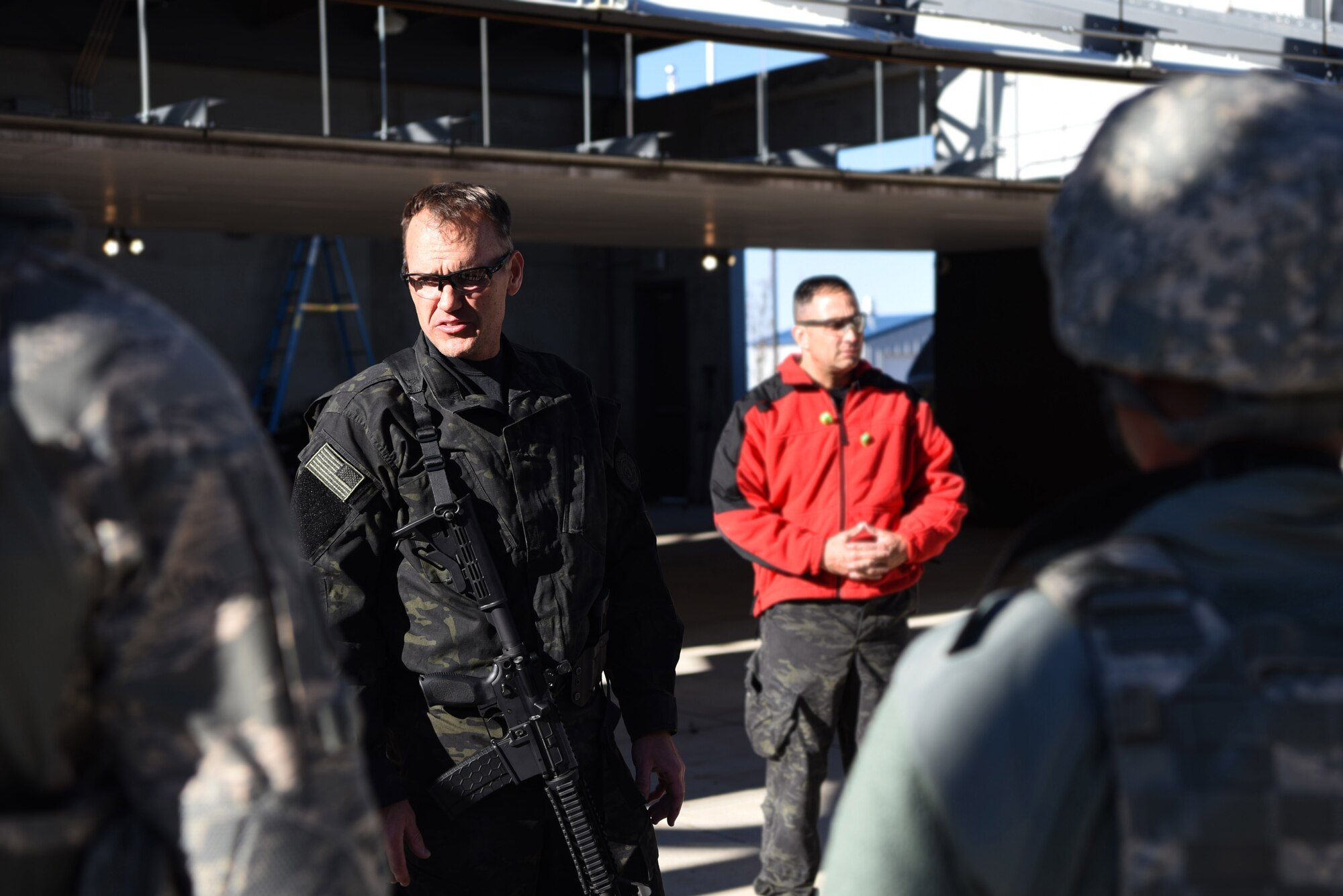 Paul Gregory, Adam County Sheriff Department academy director and training unit commander, briefs the 460th Security Forces Squadron Emergency Services Team Apr. 22, 2017, at the Flatrock Regional Training Center in Commerce City, Colo. Gregory, and team members from the Adams County Sheriff Department Special Weapons and Tactics team, spent three days training the 460th SFS EST in tactical movements for several possible scenarios. (U.S. Air Force photo by Airman 1st Class Holden S. Faul/ Released)
