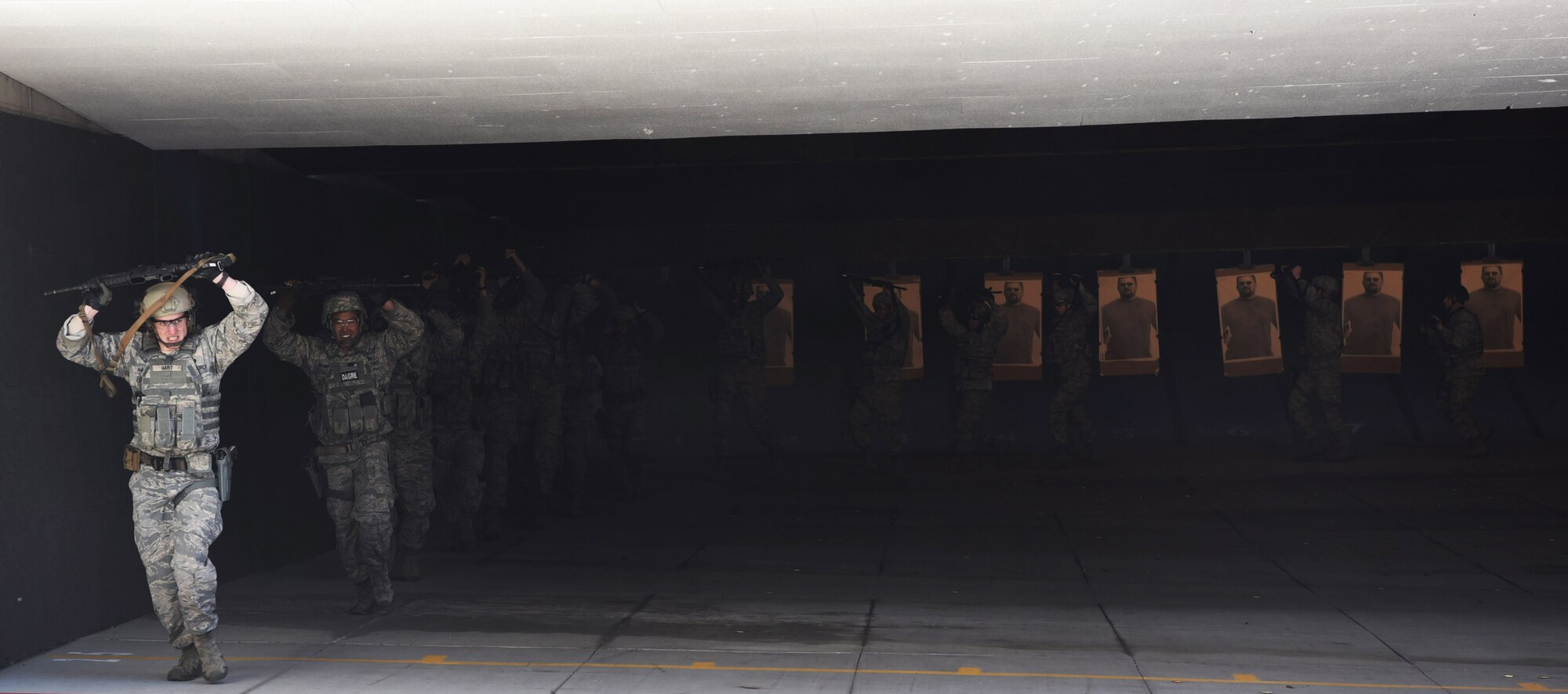 Members from the 460th Security Forces Squadron Emergency Services Team run laps around the firing range while carrying their rifles above their head Apr. 22, 2017, at the Flatrock Regional Training Center in Commerce City, Colo.  While firing at targets during their training exercise, all members were required to run one lap for each target missed. (U.S. Air Force photo by Airman 1st Class Holden S. Faul/ Released)