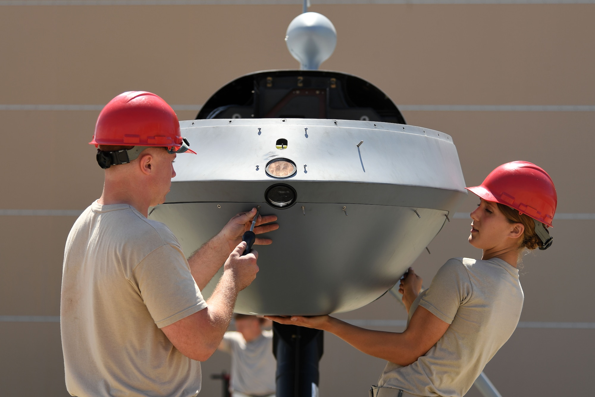 Airmen from the 432nd Aircraft Maintenance Squadron assemble an MQ-9 Reaper model for the 2017 Gulf Coast Salute Open House and Air Show April 21, 2017, at Tyndall Air Force Base, Fla.The airshow marked the first time the MQ-9 model was revealed to the public. (U.S. Air Force photo/Airman 1st Class James Thompson)
