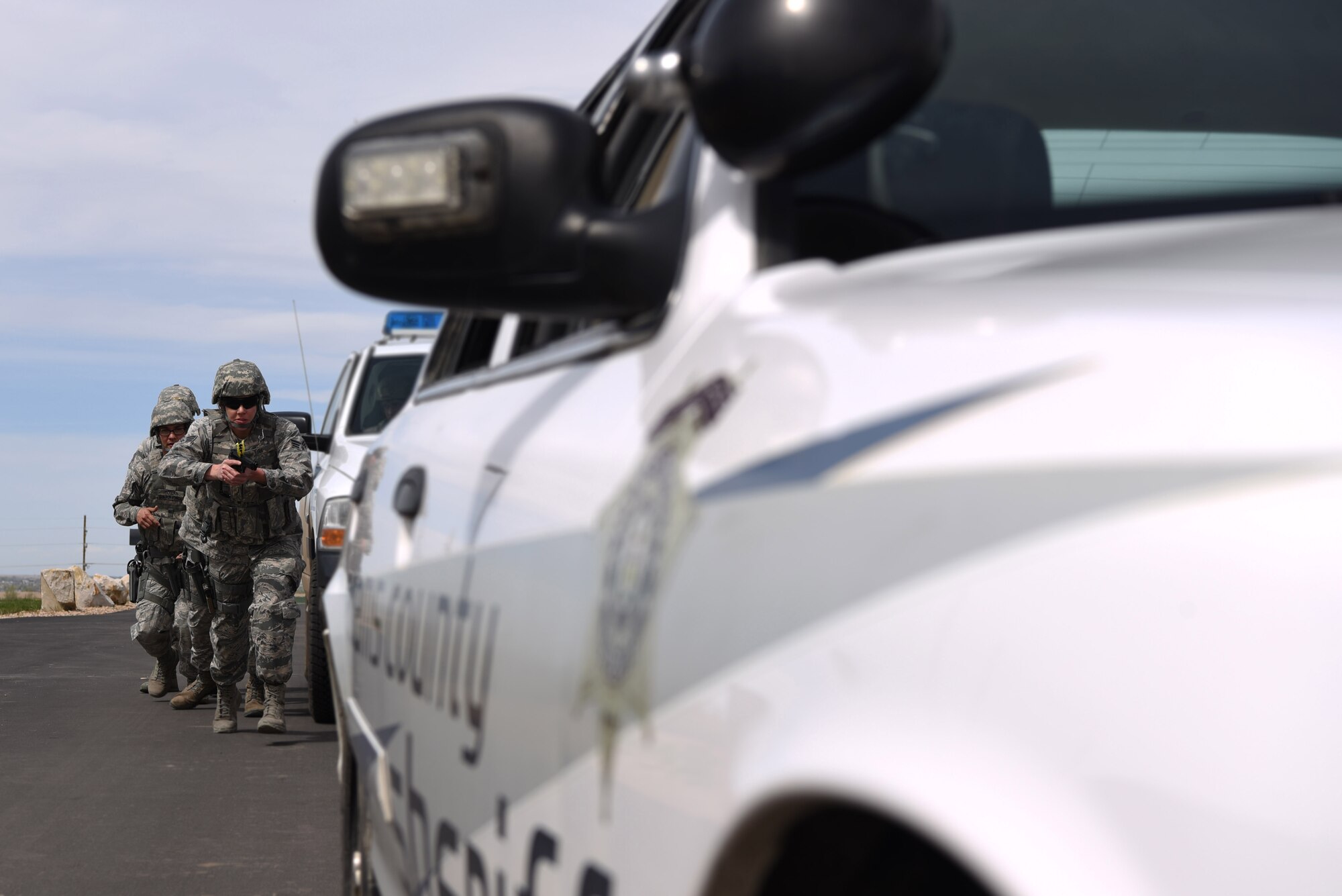 Senior Airman Rachel Kirk, 302nd Security Forces Squadron member, leads members of the 460th Security Forces Squadron Emergency Services Team as they approach a suspect’s vehicle during a training exercise Apr. 23, 2017, at the Flatrock Regional Training Center in Commerce City, Colo. Due to the 302nd SFS already having an EST, a few members decided to take the opportunity to join Team Buckley and to enhance their tactical skillsets.  (U.S. Air Force photo by Airman 1st Class Holden S. Faul/ Released)