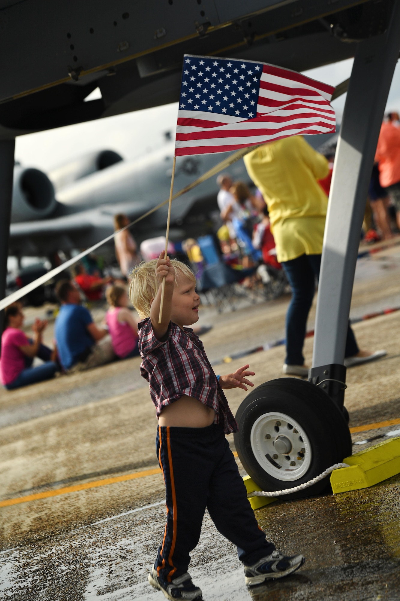 A child waves the U.S. flag in front of the MQ-9 Reaper model during the 2017 Gulf Coast Salute Open House and Air Show April 23, 2017, at Tyndall Air Force Base, Fla. Visitors of the air show were able to experience a close look at the MQ-9 model for the first time and ask questions regarding the MQ-9 capabilities and mission set. (U.S. Air Force photo/Airman 1st Class James Thompson)