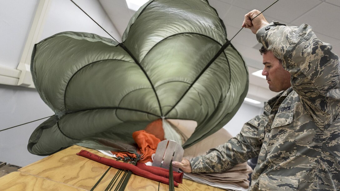 Air Force Staff Sgt. Scott Watson inspects a parachute at Robins Air Force Base, Ga., April 26, 2017. Watson is an aircrew flight equipment technician assigned to the 339th Flight Test Squadron. Air Force photo by Jamal D. Sutter