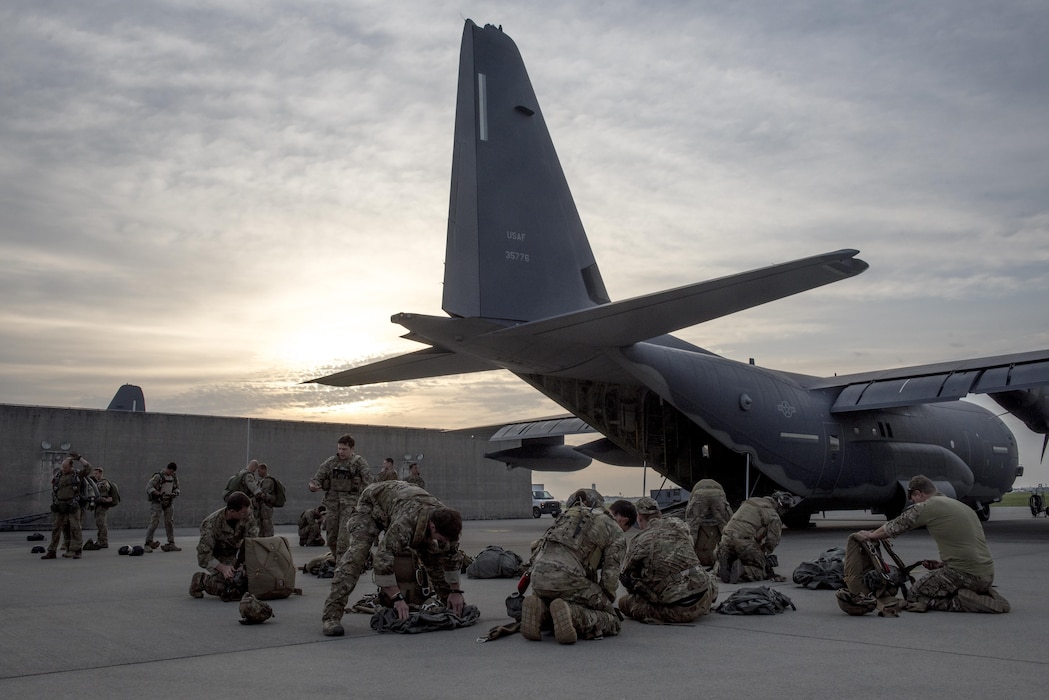 U.S. Air Force Airmen and U.S. Army soldiers prepare for parachute training on an MC-130J Commando II April 24, 2017, at Kadena Air Base, Japan. The training provided an opportunity for the sister services to learn from each other and stay proficient in their combat and life-saving skillsets. (U.S. Air Force photo by Senior Airman John Linzmeier)