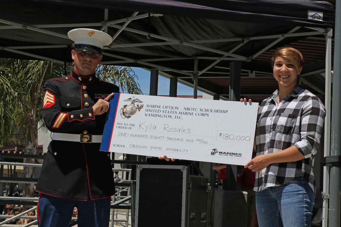 Sergeant Brian Robert, recruiter of Recruiting Sub Station Ventura, presents a Naval Reserve Officers Training Corps Scholarship check to Kyla Rosales at Foothill Technology High School in Ventura, Calif., April 26, 2017. The NROTC scholarship, valued at up to $180,000, will pay for the cost of full tuition, books and other educational fees at many of the country’s leading colleges and universities. (U.S. Marine Corps photo by Staff Sgt. Alicia R. Leaders/Released)
