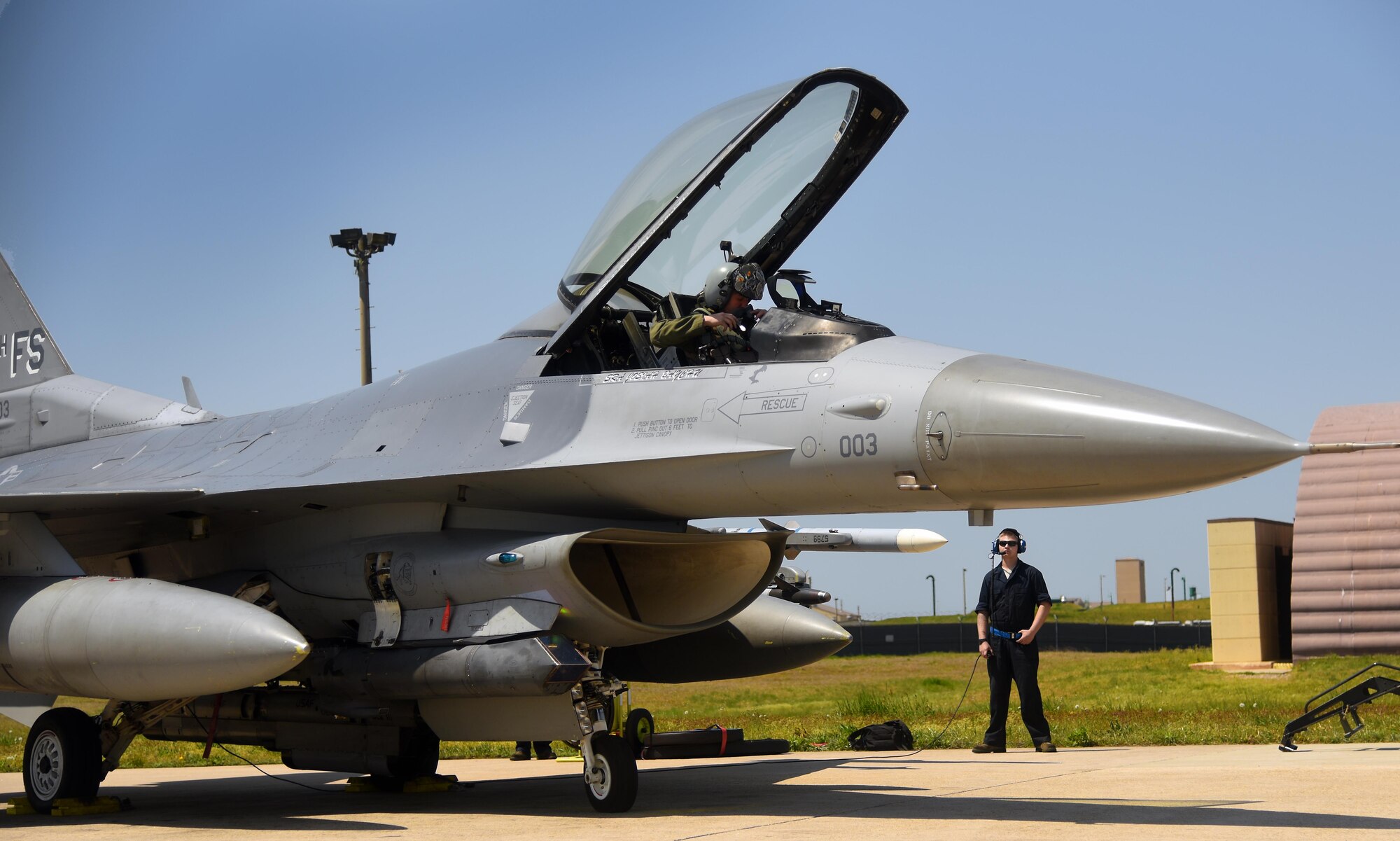 U.S. Air Force 1st Lt. Glenn Miltenberg, 35th Fighter Squadron pilot, and Airman 1st Class Austin Willey, 8th Aircraft Maintenance Squadron crew chief, conduct a communications check during Exercise MAX THUNDER 17 at Kunsan Air Base, Republic of Korea, April 27, 2017. Max Thunder is part of a continuous exercise program to enhance interoperability between U.S. and ROK forces. (U.S. Air Force photo by Tech. Sgt. Jeff Andrejcik/Released)